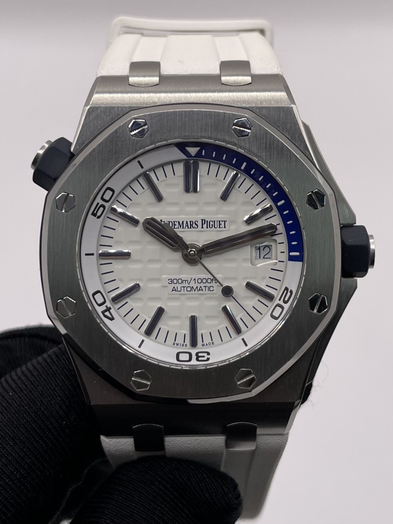May be an image of wrist watch and text that says 'AAaAHe 50 -DEMARS DEMARSPIGUET DEMARS PIGUET 300m/1000fb 1000f 300m/ AUTOMATIC 40 Ν O WIDE M LAD ADE WISS 3'
