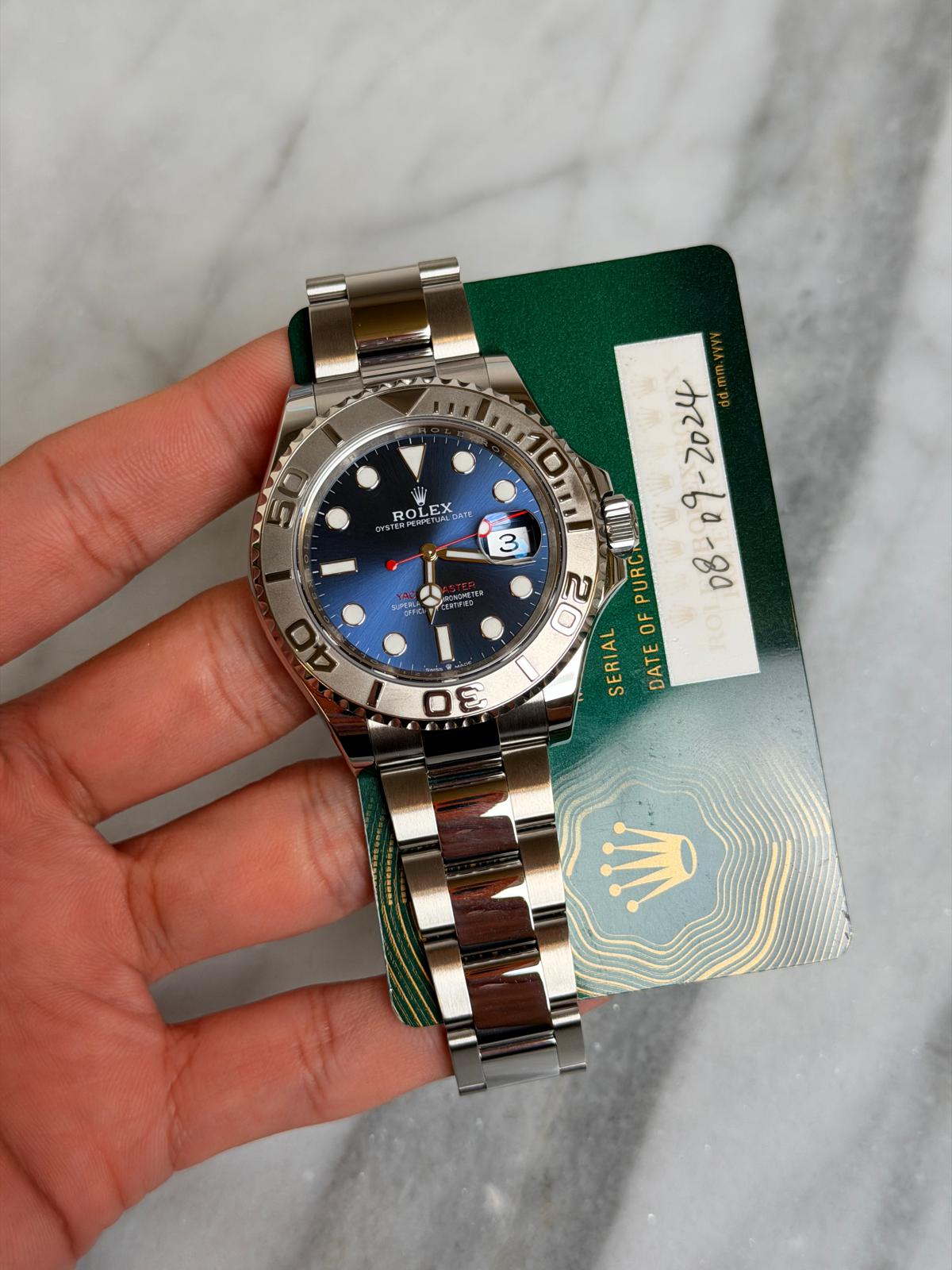 May be an image of wrist watch and text that says 'ROLETDAT ርዶያዊ ロれ ROLE E 3 IUN 20 PURC - SERIAL OF PAW RoI DATE 20 3 mi'