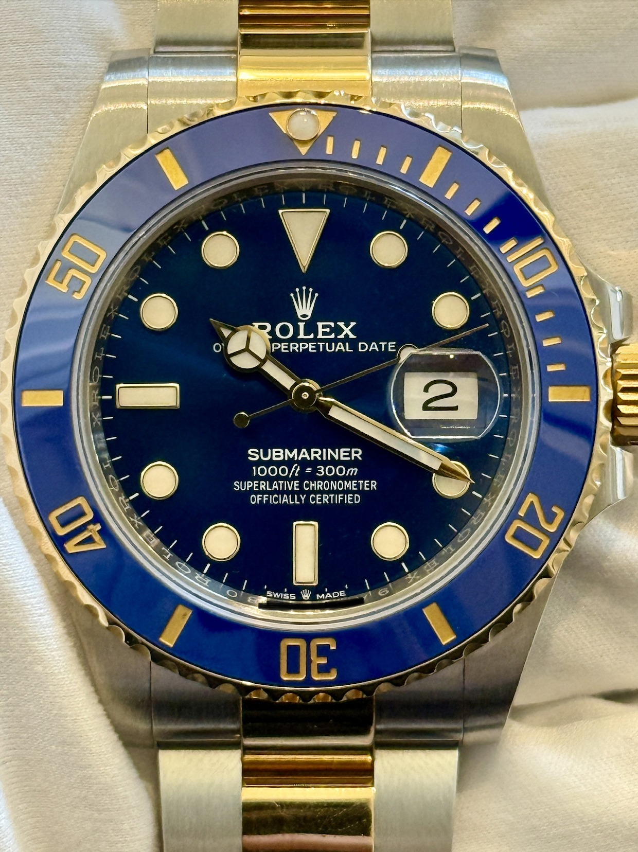 May be an image of wrist watch and text that says '50 O' ROLEX PERPETUAL DATE 10, 2 - SUBMARINER 1000ft= SUPERLATIVE SUPERLATIVECHRONOMETER CHRONOMETER OFFICIALLY…