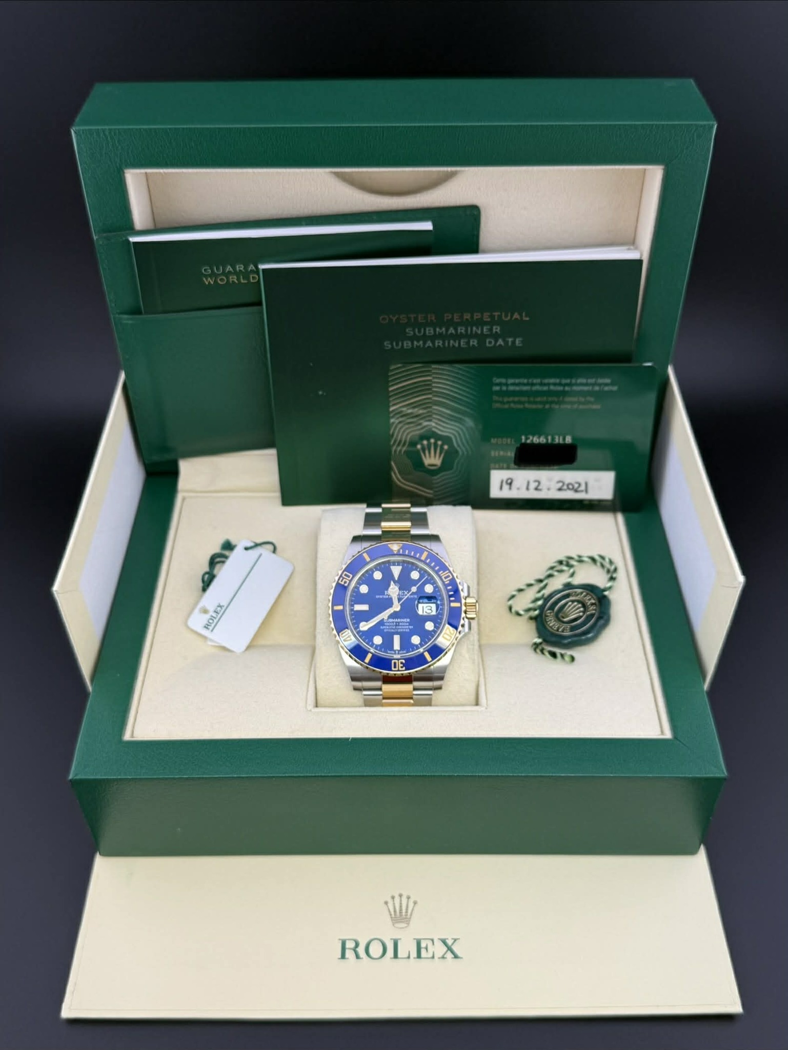May be an image of wrist watch and text that says '126613L 2o21 • A 50 4 ROLEX ROLEX 13 1 DE 0S ROLEX'