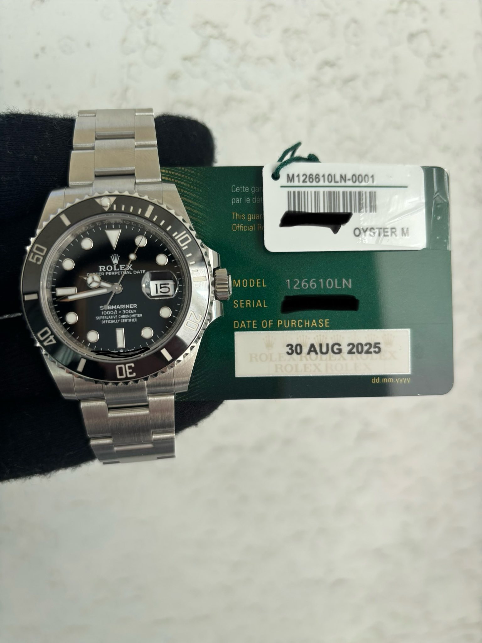May be an image of wrist watch and text that says 'M126610LN- ROLEX EXX ROL OYSTER M 15 SUMARINER PERANECCERFE Cenokcr 春 10DEL126610LN ODEL 126610LN 40 ATEOFPURCHASE OE ROL…