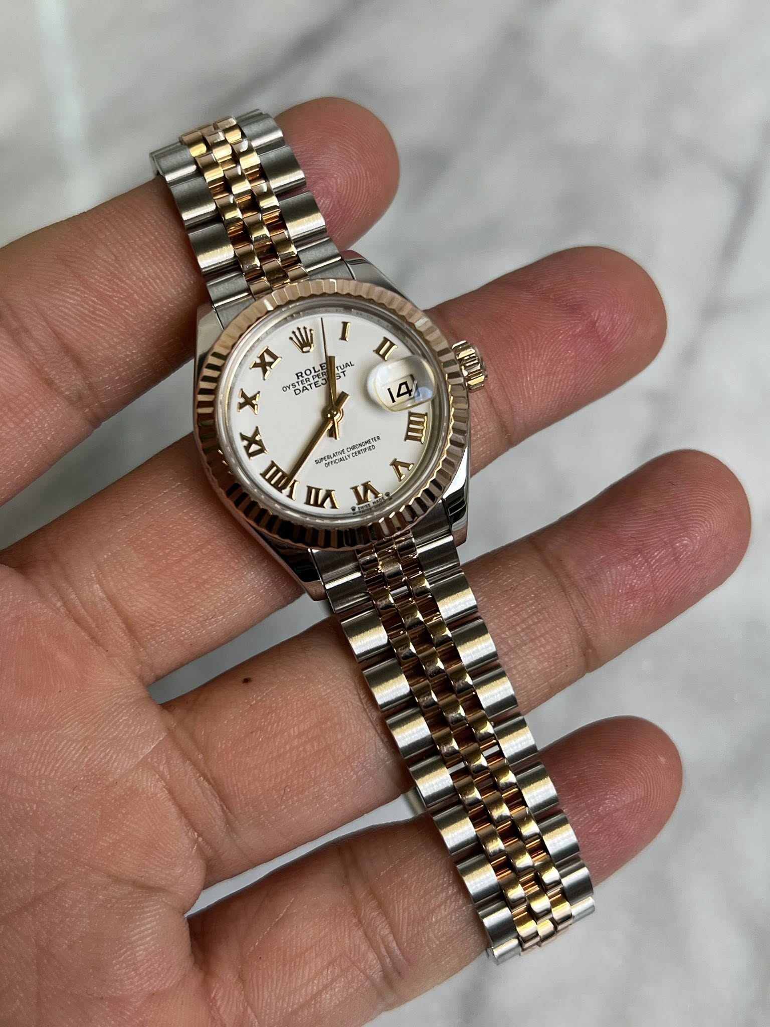 May be an image of wrist watch and text