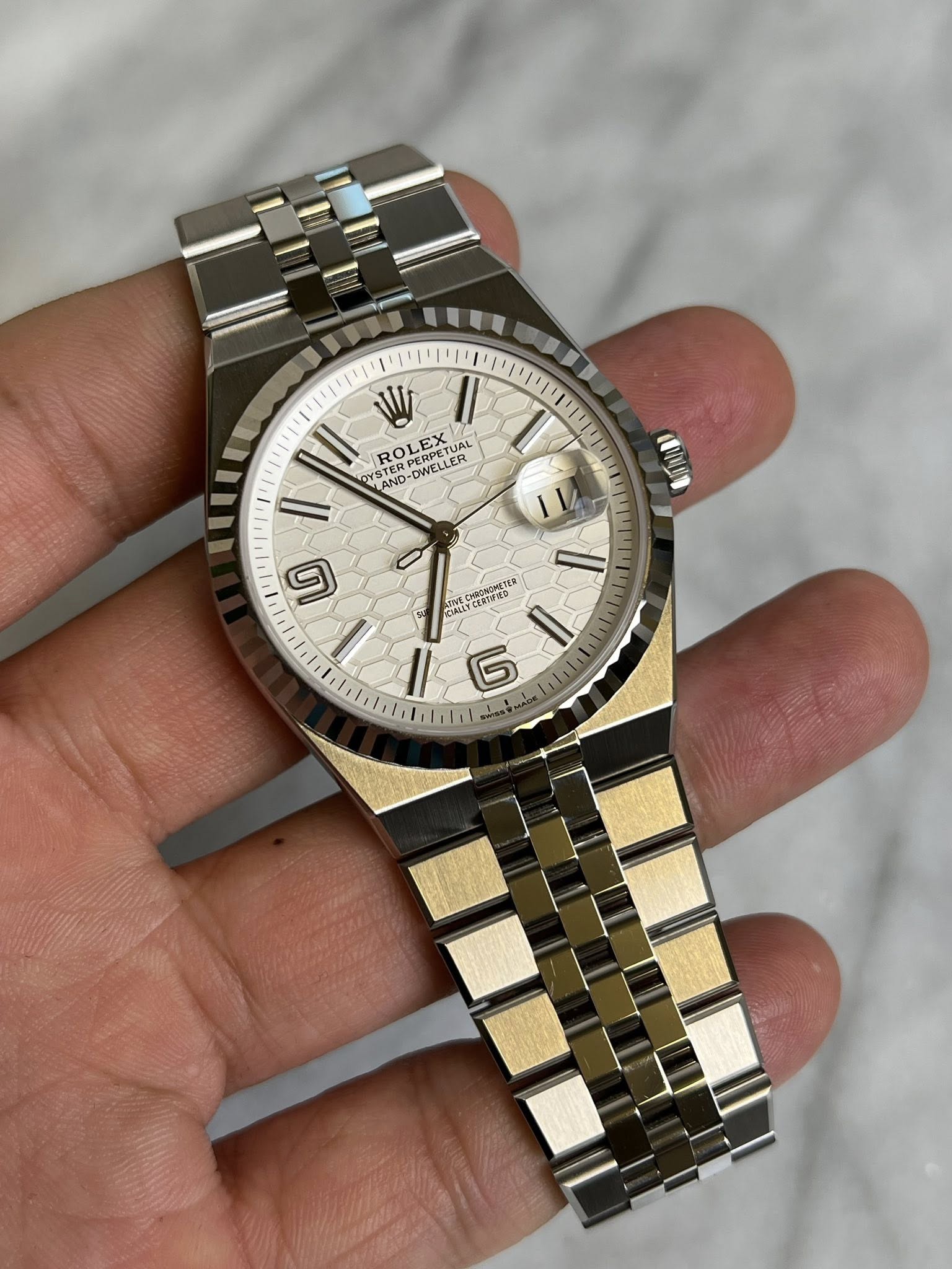 May be an image of wrist watch and text
