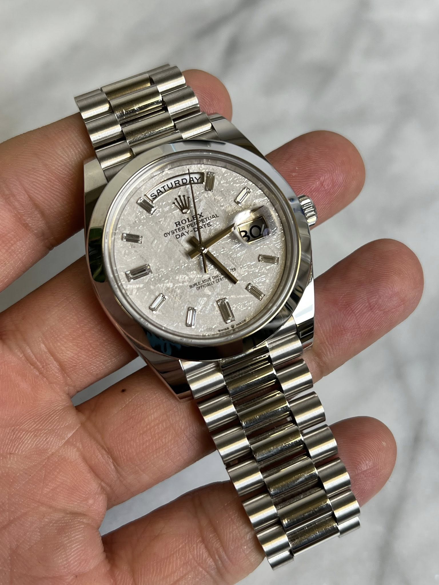 May be an image of wrist watch and text
