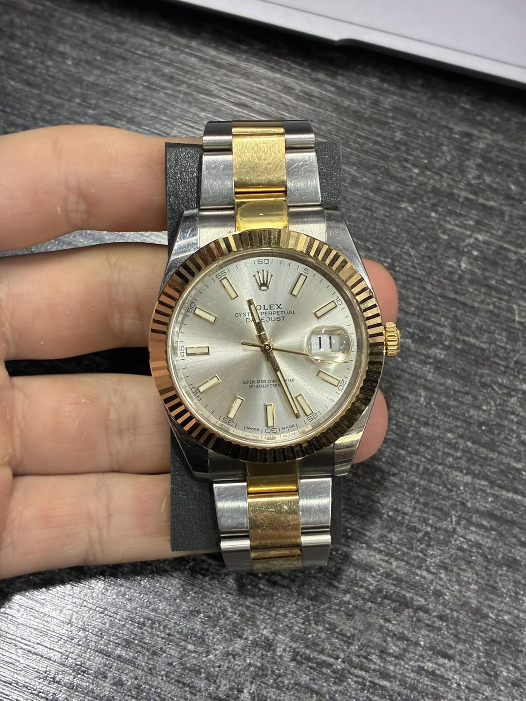 May be an image of wrist watch and text