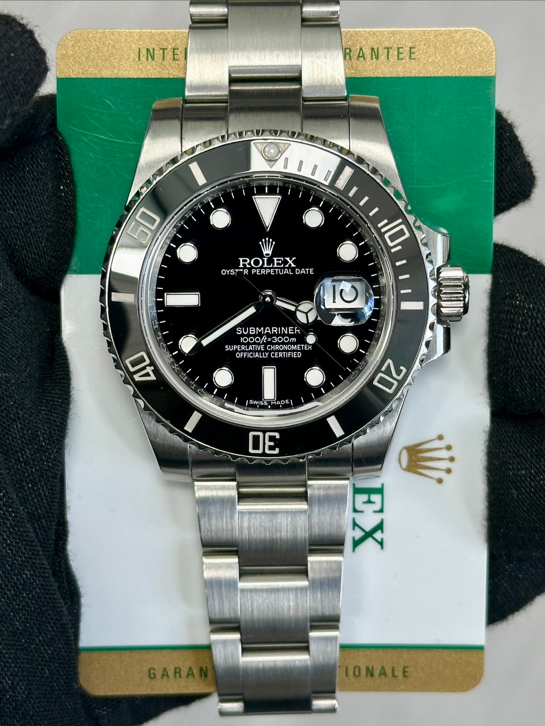 May be an image of wrist watch and text that says 'INTE RANTEE 50 ROLEX OYST-RPERPETUALDATE LEX OYST PERPETUAL DATE 10 10 SUBMARINER ooft= 1000f= =300m SUPERLATIVE e RLATIVE…