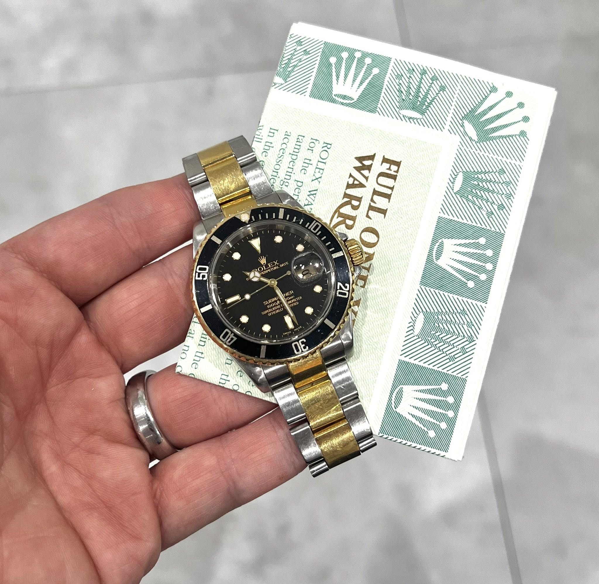 May be an image of wrist watch and text