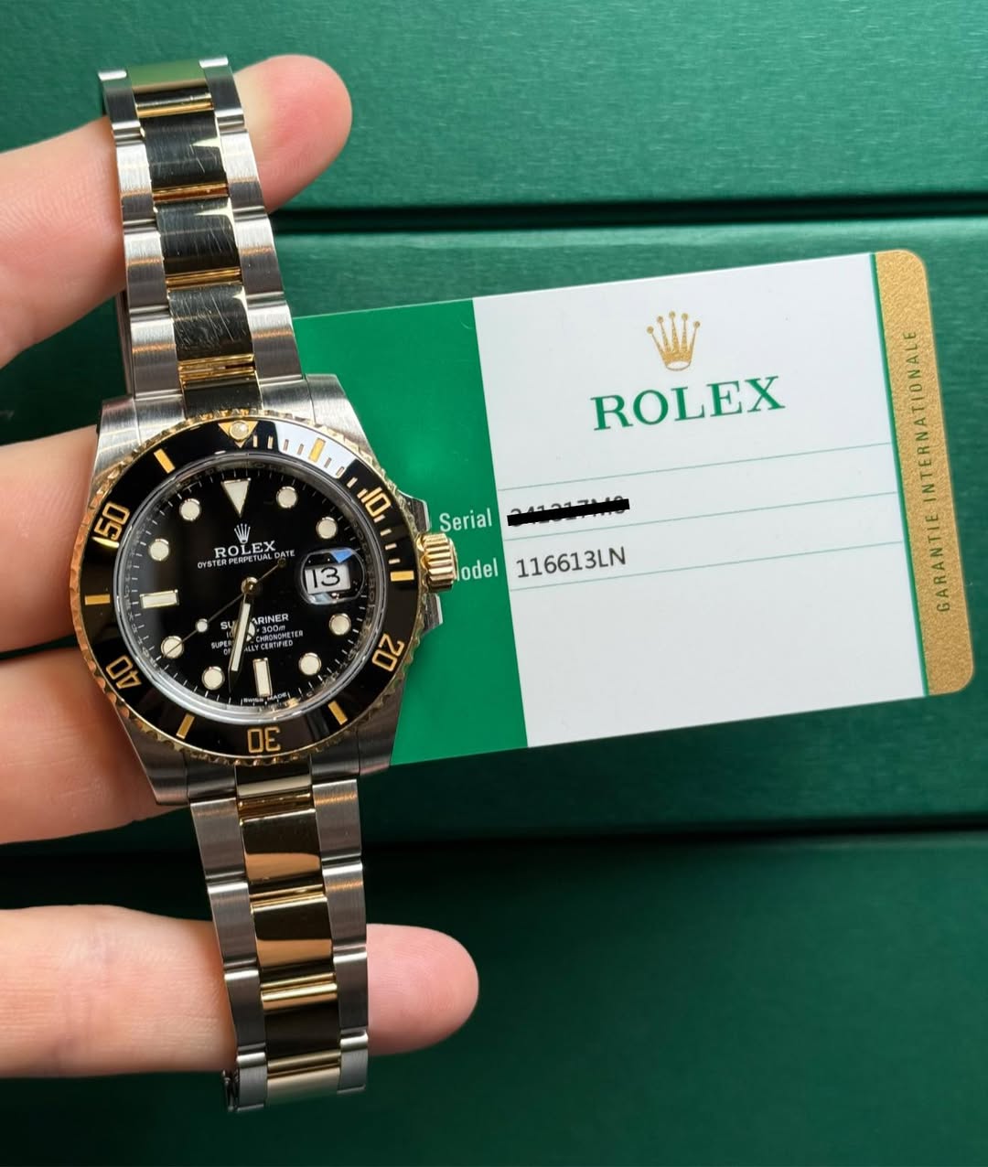 May be an image of wrist watch and text that says ' ROLEX LF ROA OLI DATE ማቆን ROLEX 13 تته Serial مسحمممد odel 116613LN sy ARINER ARINER 40 20 D0 GARANTIE'