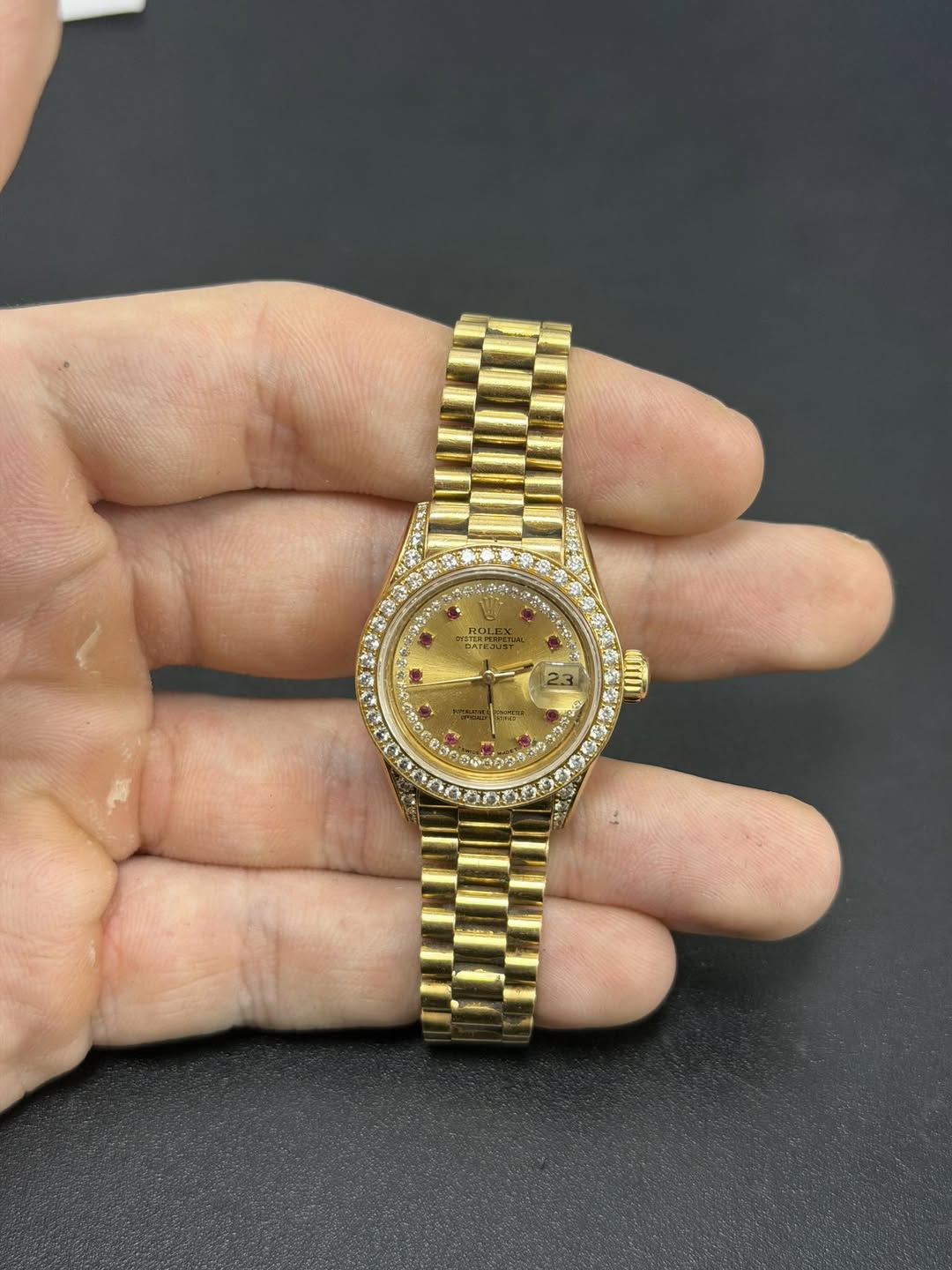 May be an image of wrist watch and text