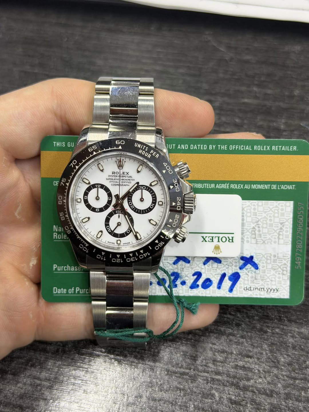 May be an image of wrist watch and text that says 'THIS GU 60 65 70 UNIT UT AND DATED BY THE OFFICIAL ROLEX RETAILER. HOUR PER 400 ن SET LEX NE HGLETIVe PERPCTURL OEE OONCLNE…