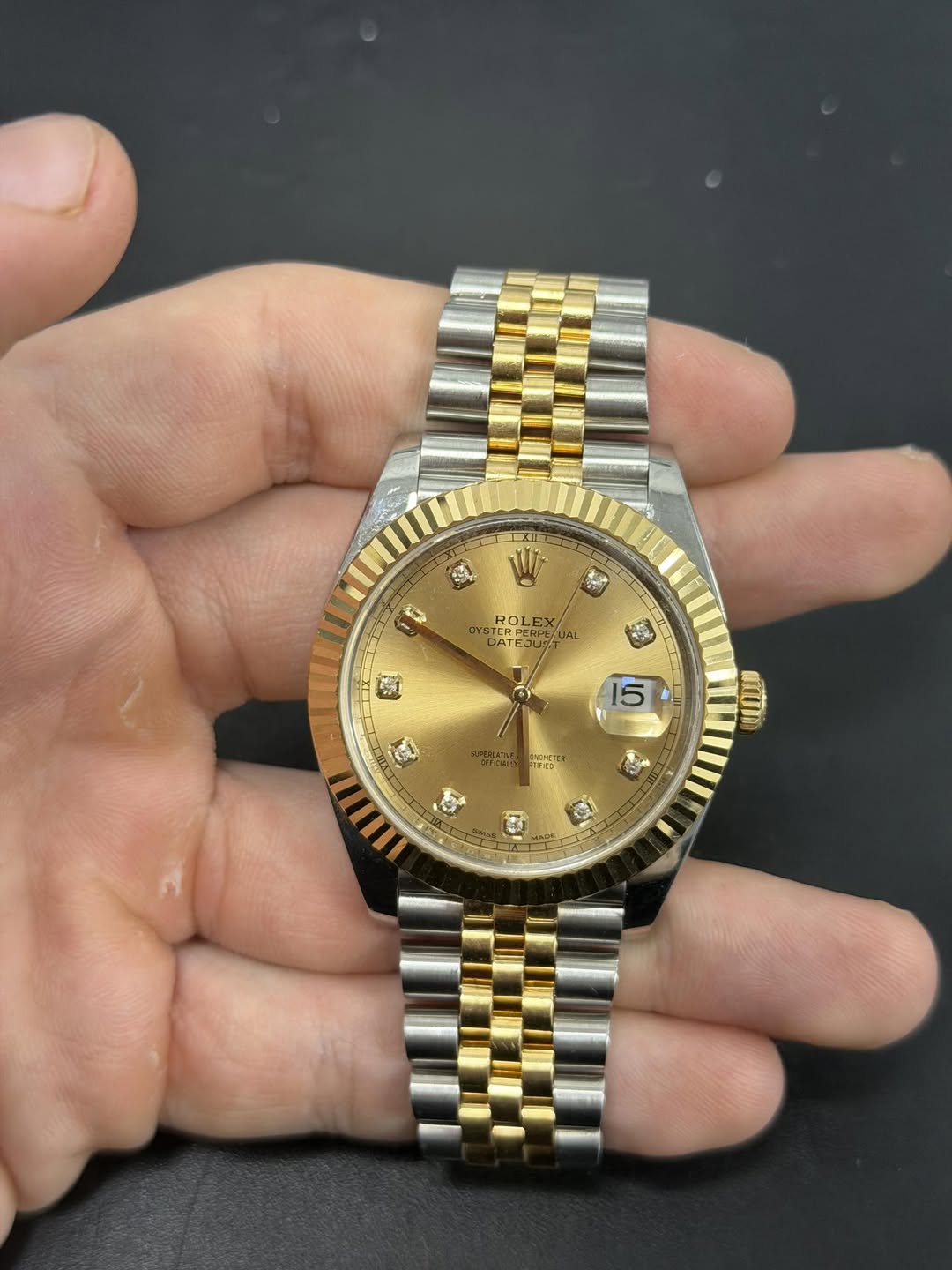 May be an image of wrist watch and text