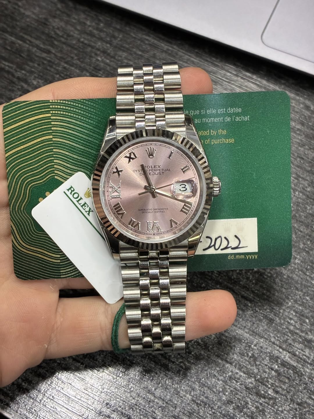 May be an image of wrist watch and text