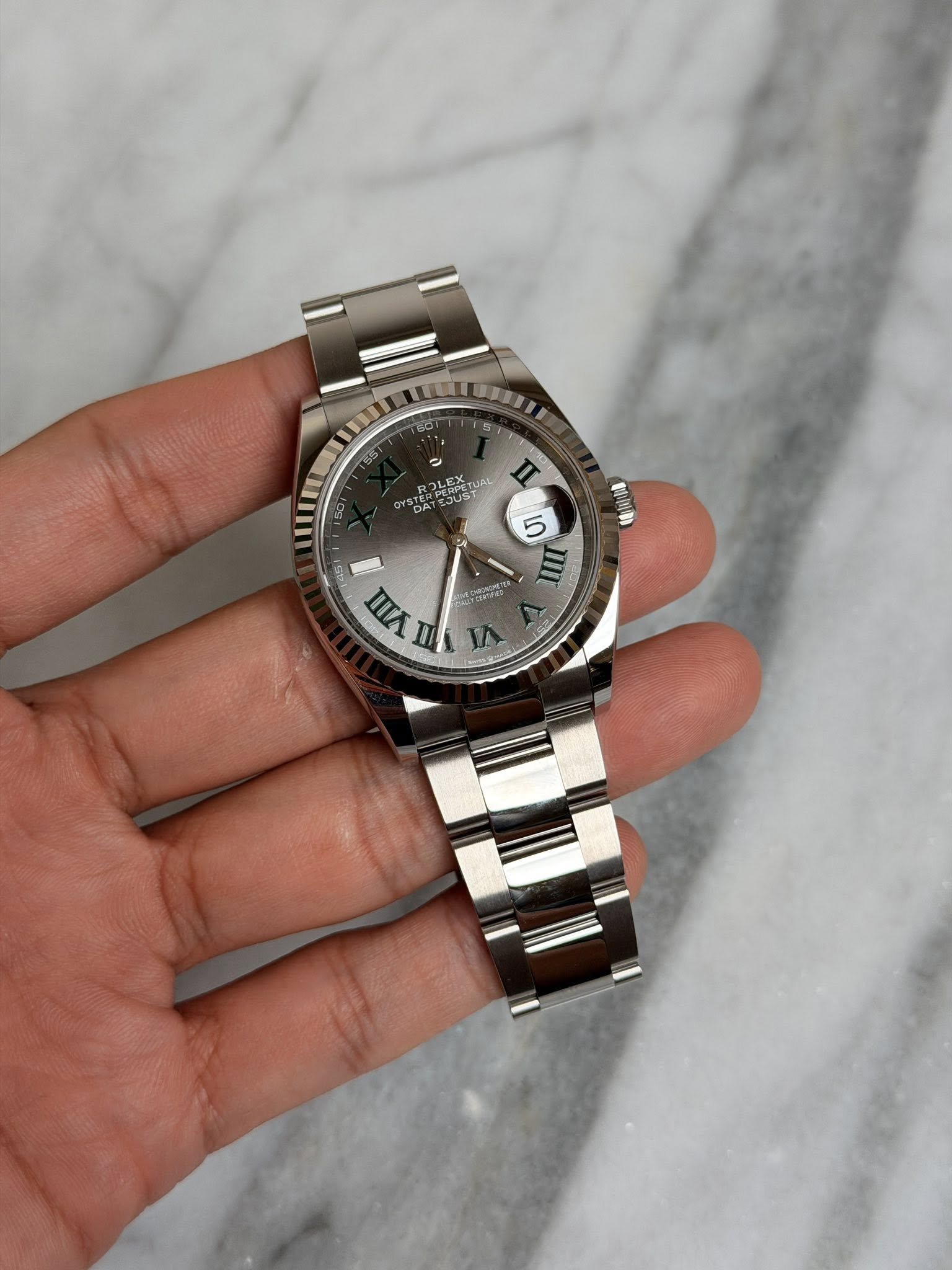 May be an image of wrist watch and text