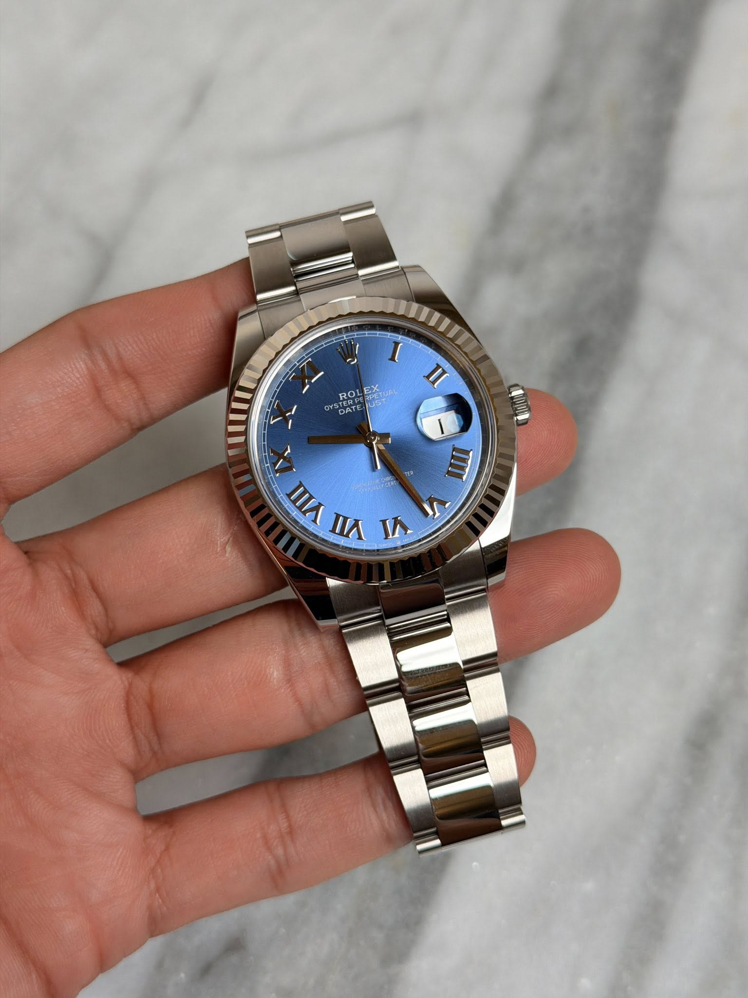 May be an image of wrist watch and text