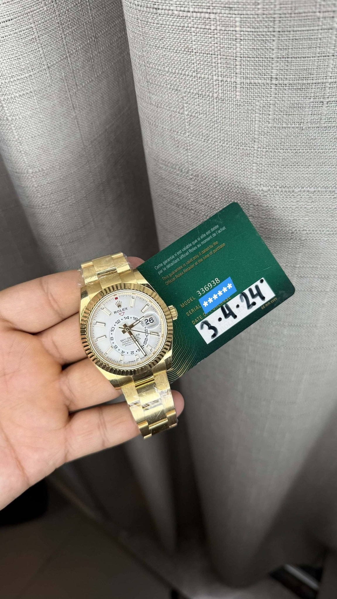 May be an image of money, wrist watch and text