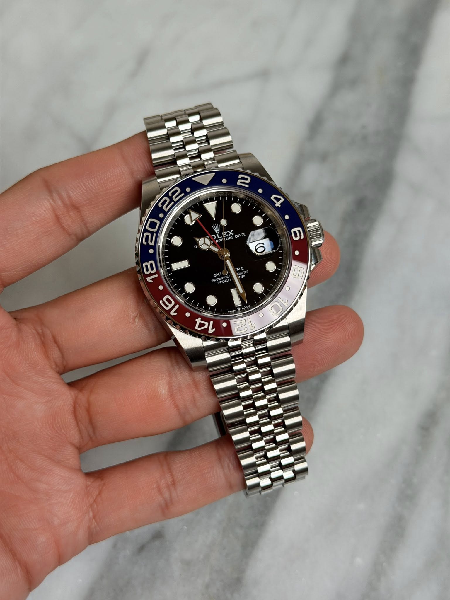 May be an image of wrist watch and text