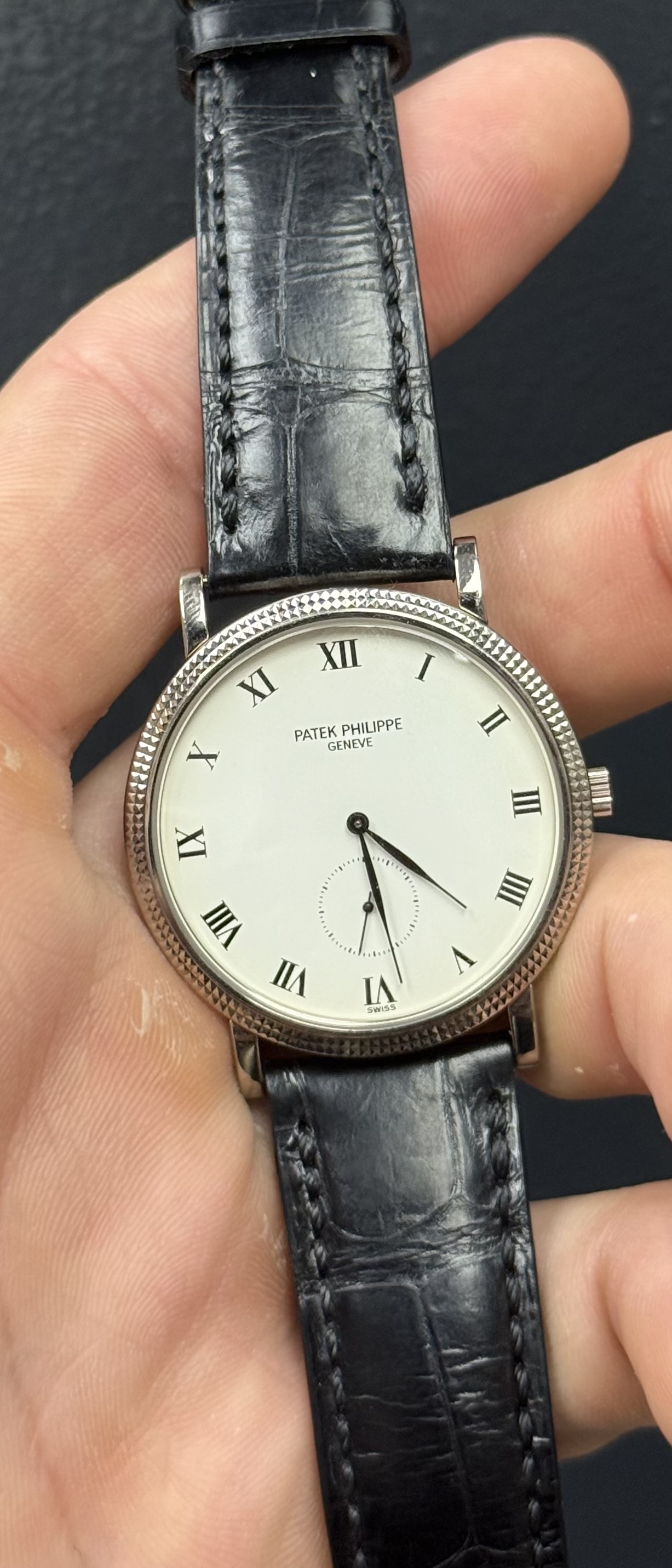 May be an image of wrist watch, leather and text that says '2 XII I XI PATEKPHILIPPE PATEK HILIPPE X GENEVE n IX W ወ III VI u I IA B0A3'