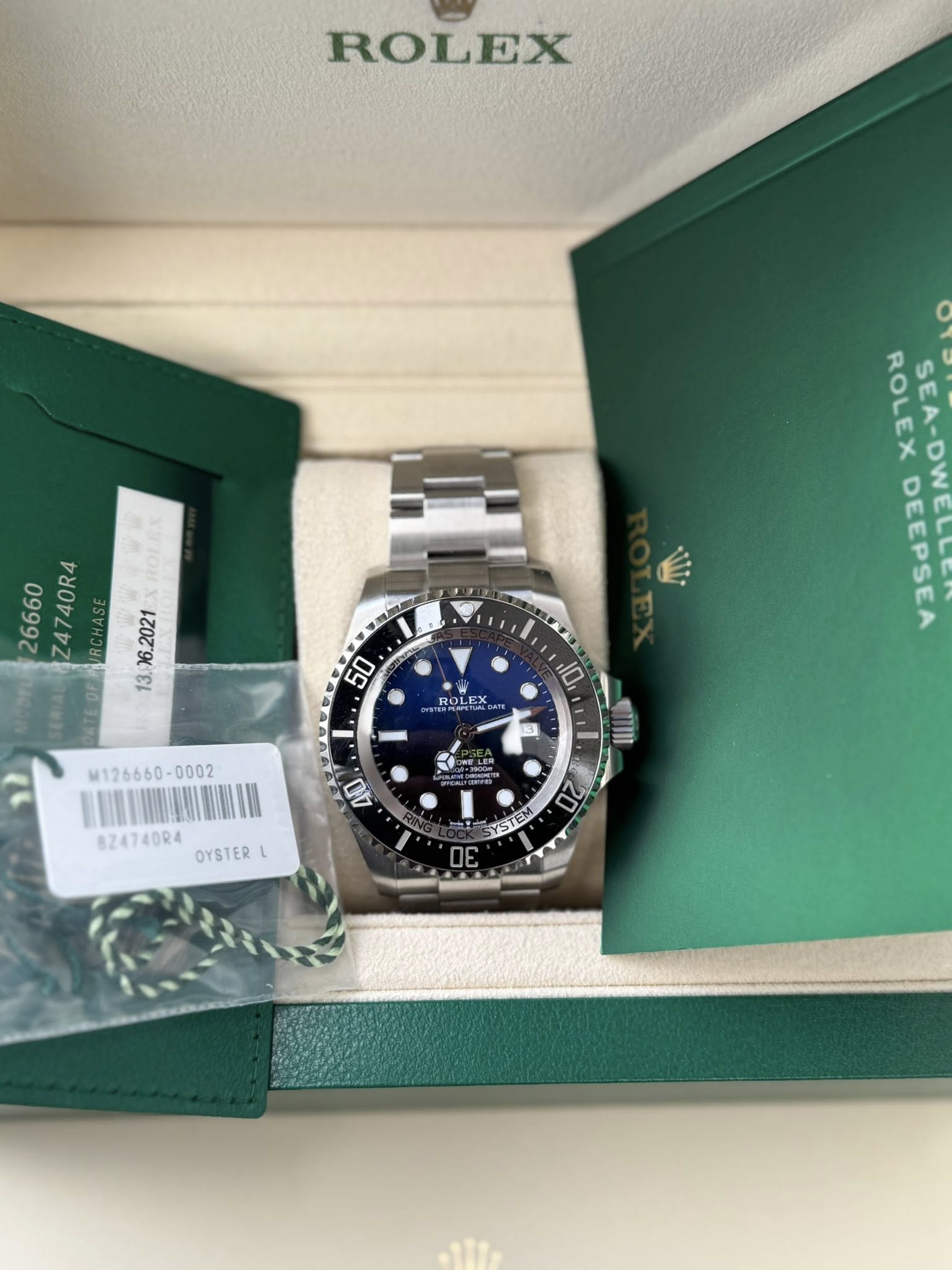 May be an image of wrist watch and text that says 'ROLEX 26660 Z4740R4 - M126660- እልማ2ም 10 ROLEX LEX 立 YSTEM ELSA 20 OE 40 824740R4 OYSTER L'