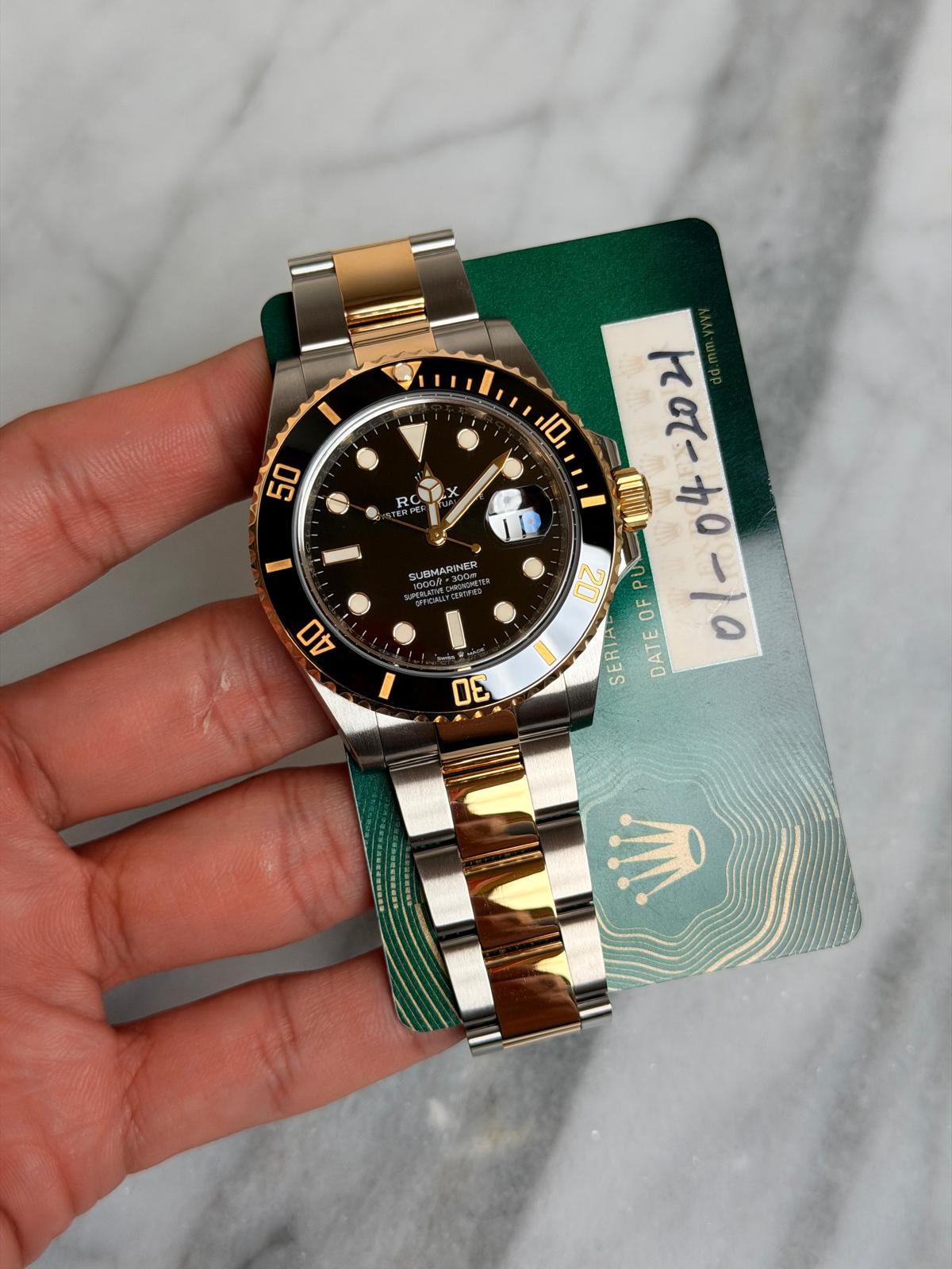 May be an image of wrist watch and text that says 'I 50 X RC SUBMARINER Y n OF SERIA DATEOFPU U P DATE ٥ 0 40 DE'