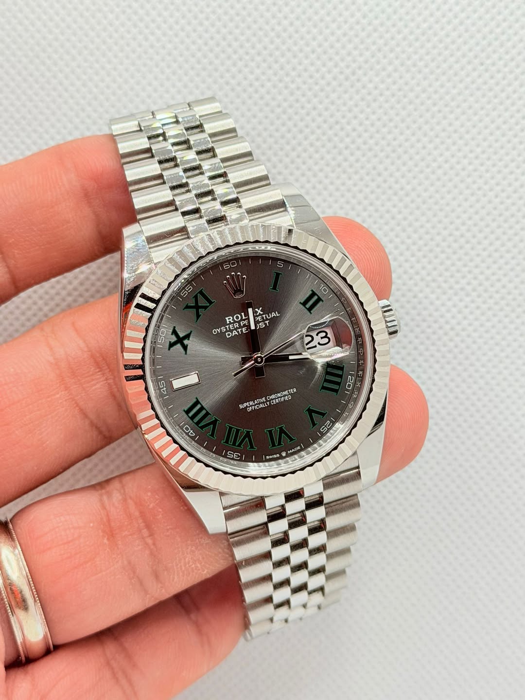May be an image of wrist watch and text