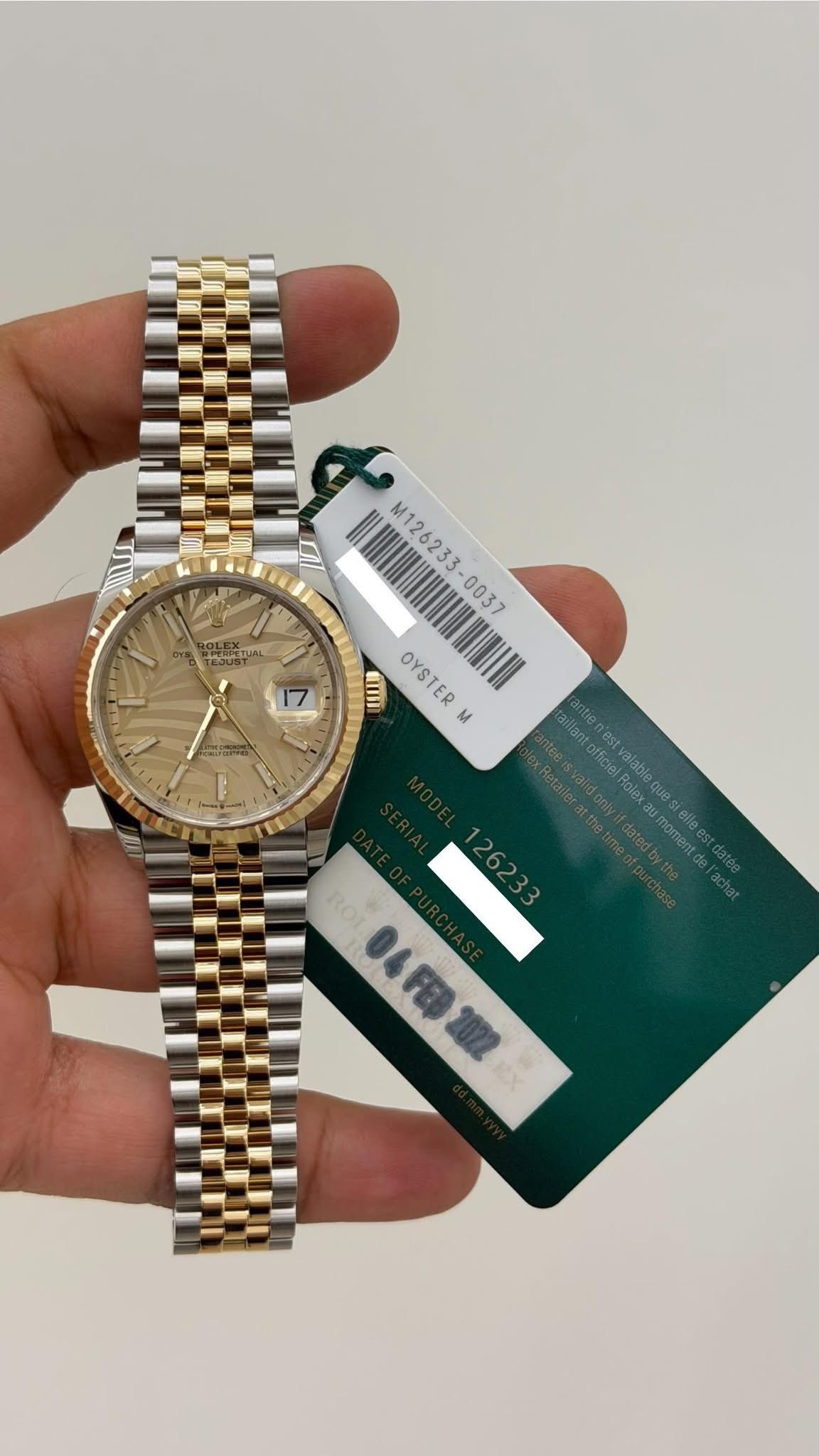 May be an image of wrist watch and text that says 'M126233-0037 M126233 NH M126 II OYSTER L 12623 04FE2022'