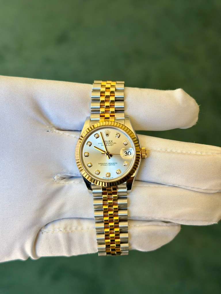 May be an image of wrist watch and text