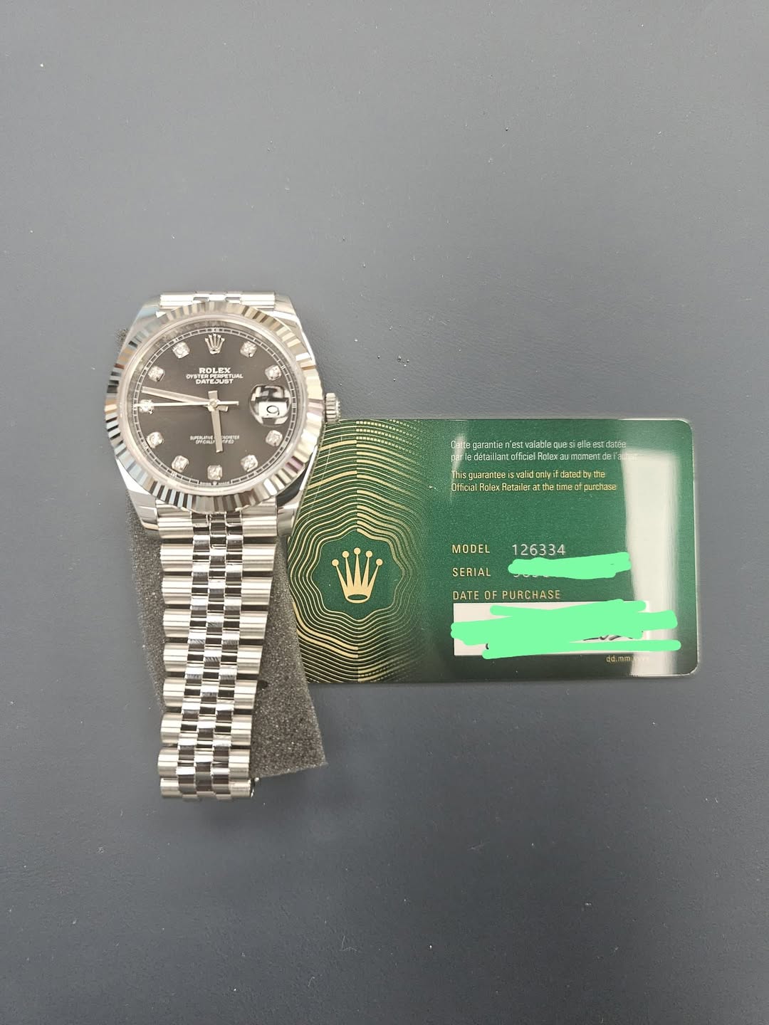 May be an image of wrist watch, ticket stub and text