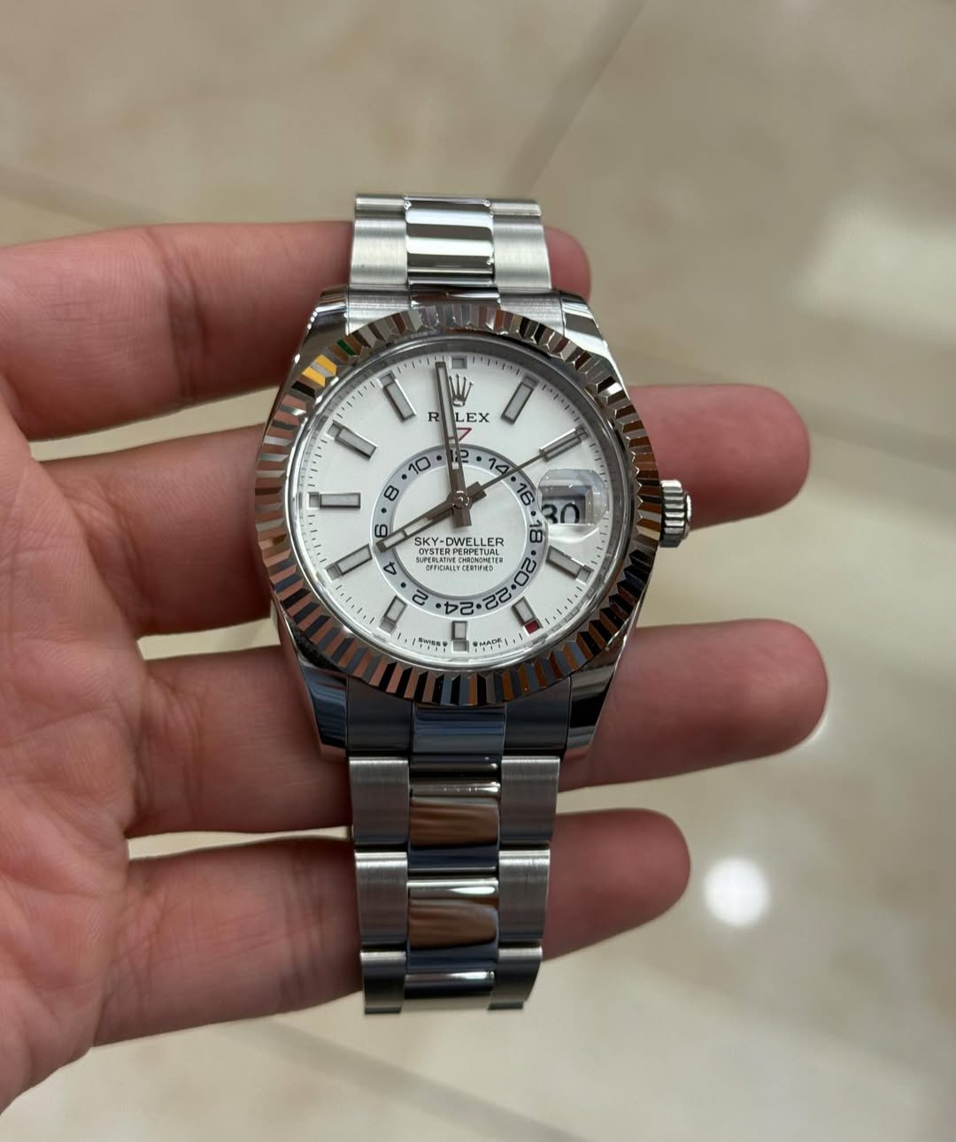 May be an image of wrist watch and text