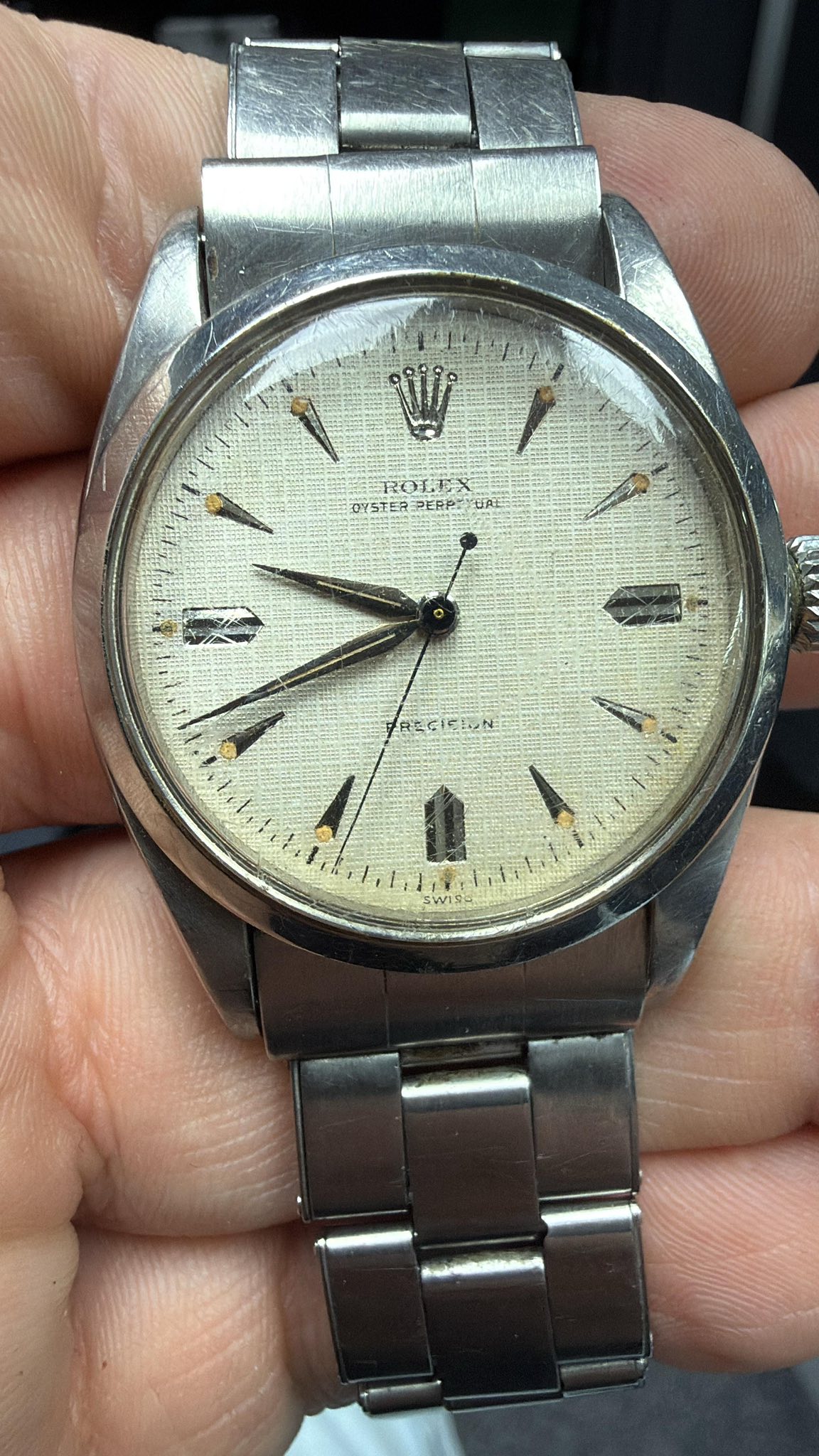May be an image of wrist watch and text