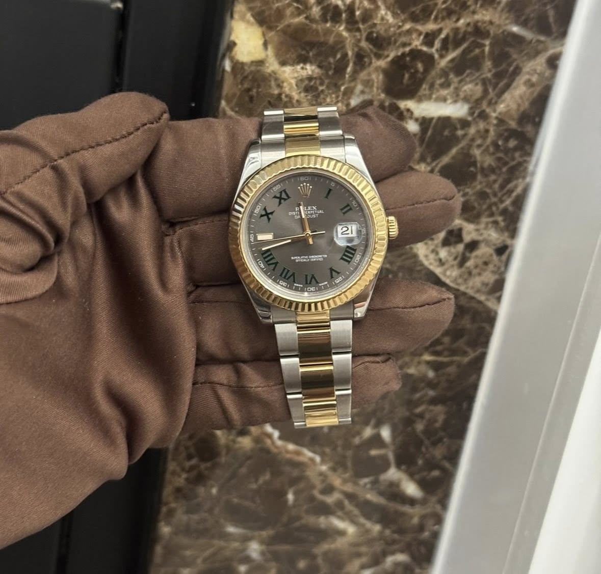 May be an image of wrist watch and text