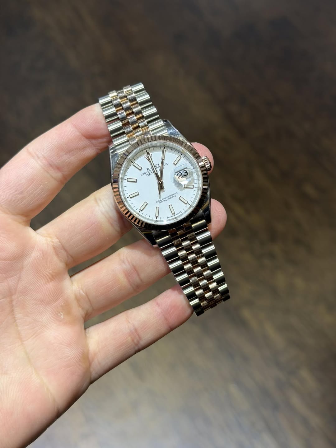 May be an image of wrist watch and text