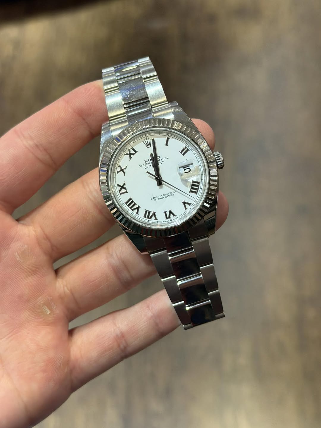 May be an image of wrist watch and text