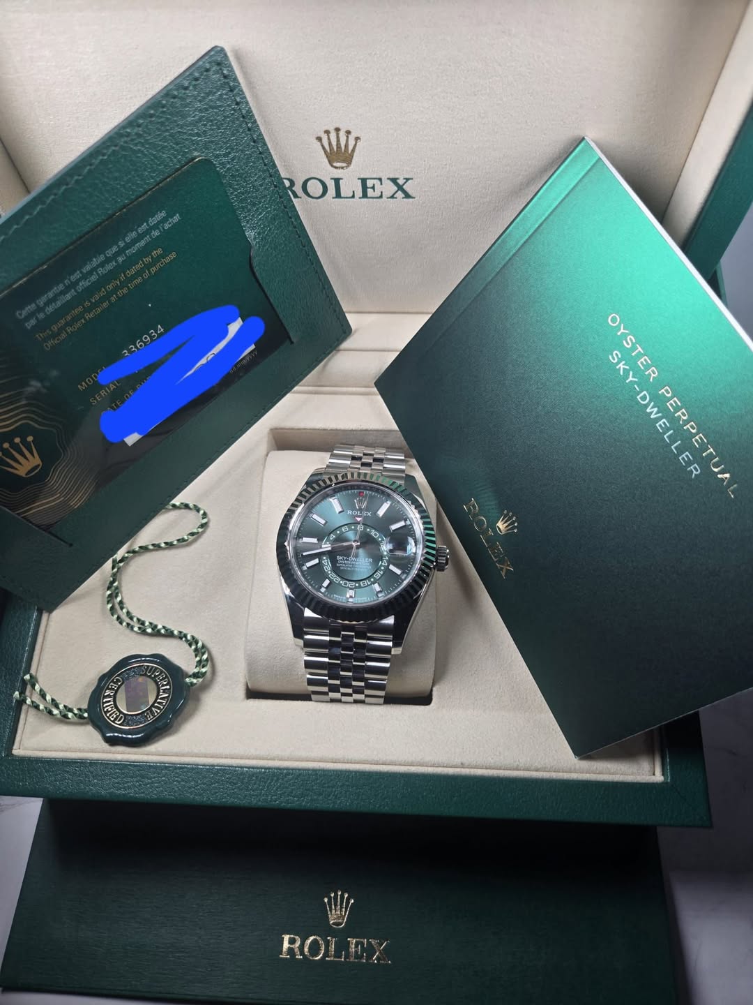 May be an image of wrist watch and text that says 'WI ROLEX 36934 EN W LS อ 15 F キン ၁၀၃ ម لعه SKY-DWELLER បិង SKY- OYSTER PERPETUAL - ROLEY'