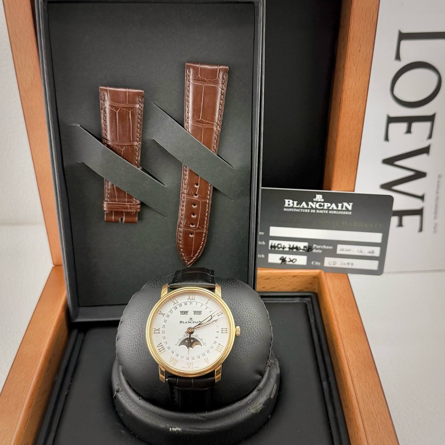 May be an image of leather, wrist watch and text