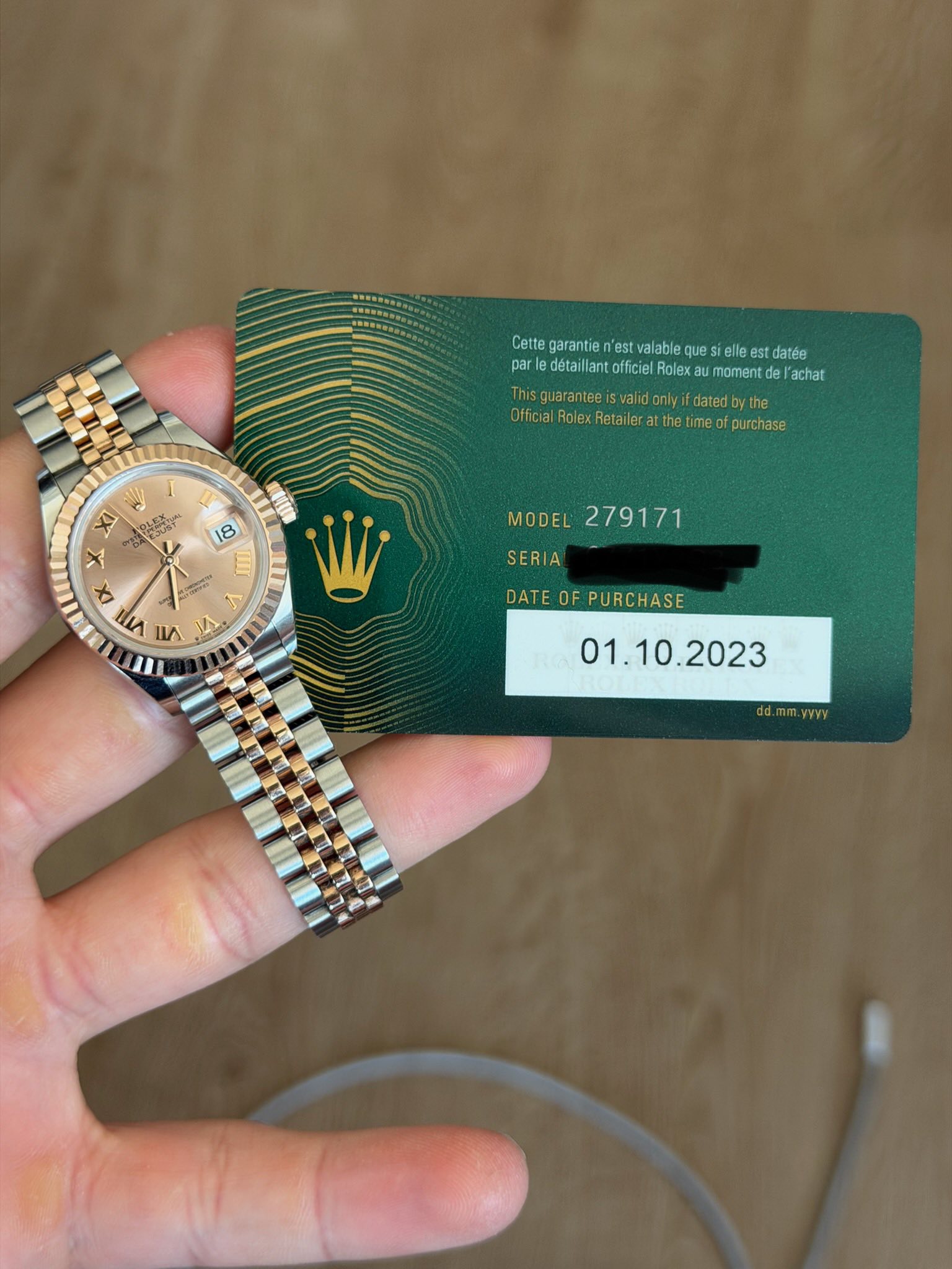 May be an image of money, wrist watch and text