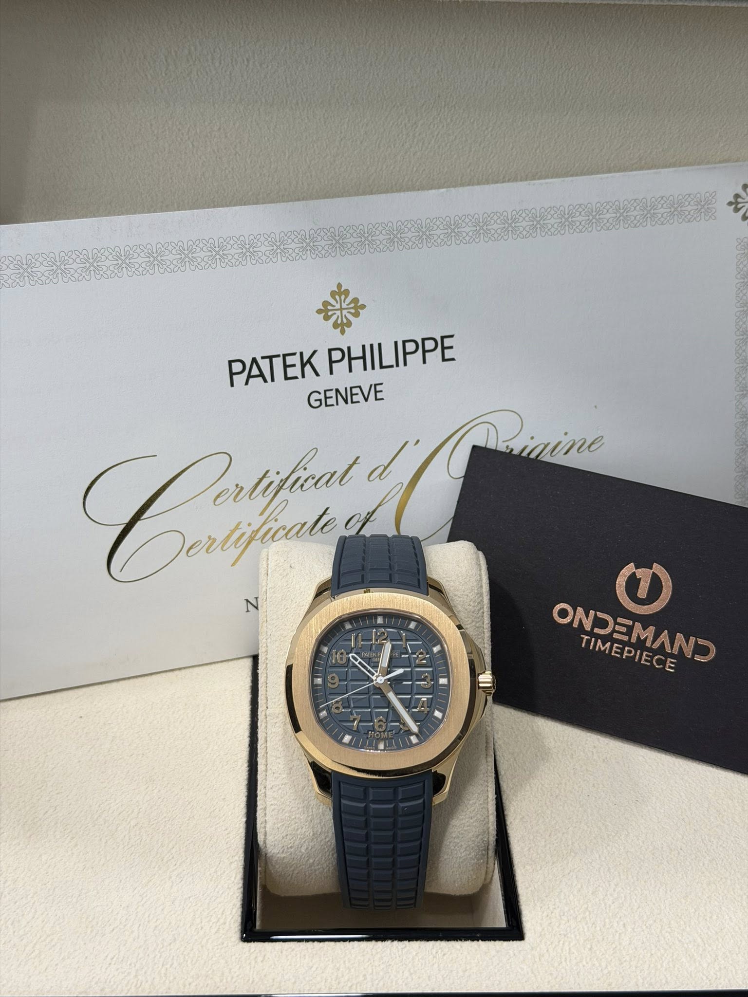 May be an image of wrist watch and text that says 'PATEKPHILIPPE PATEK PHILIPPE GENEVE Caжфии Dertificale d' Prinina igine N مر - - ONDOMANO ONDEMAND TIMEPIECE'