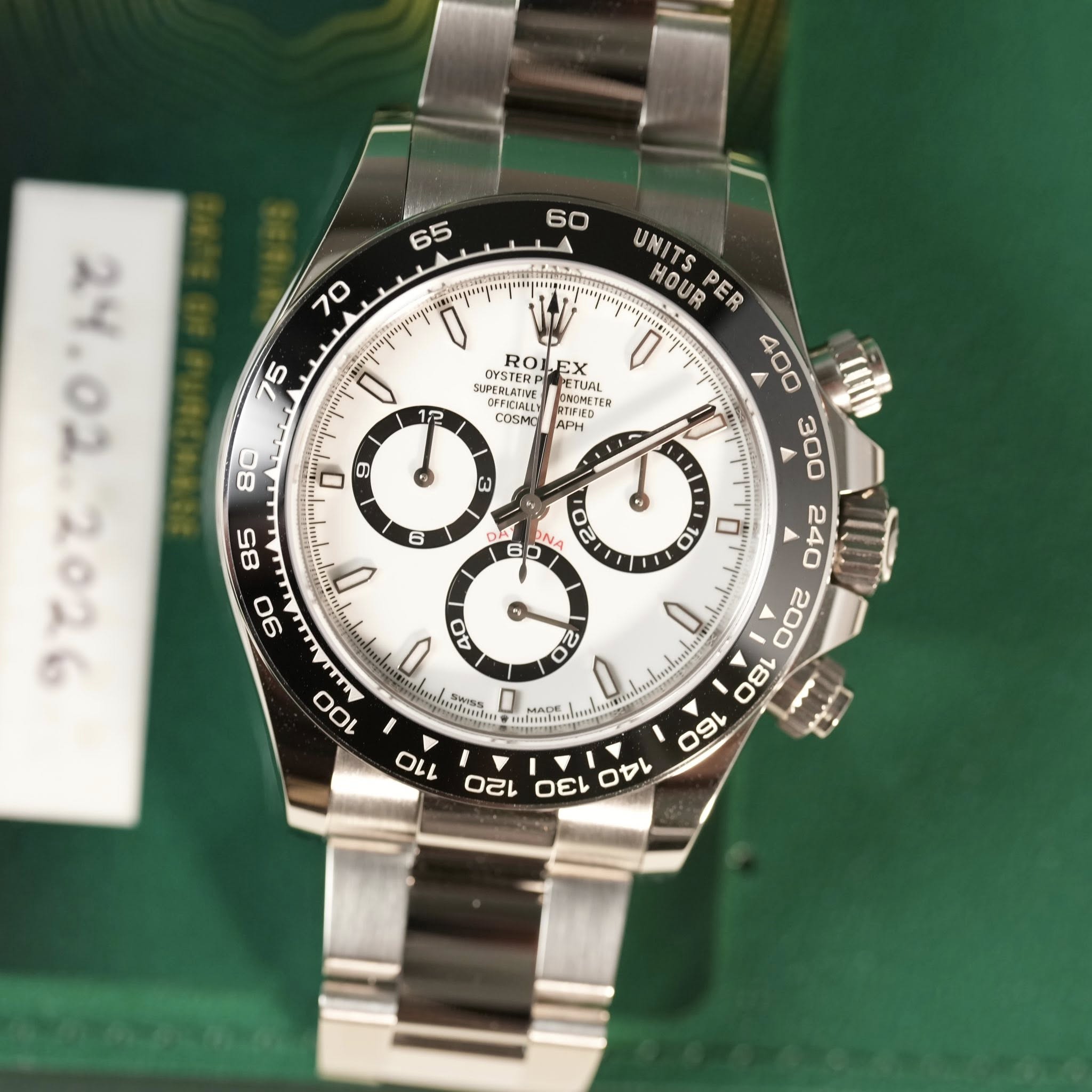 May be an image of wrist watch and text that says ' SUDESTER OYSTERD ROLEX RO PETUAL UAL IN OFFICIALL ONOMETE ITER METER COSMO OFFICIALL COSr RTIFIED APH 0 0 3 6 UNITS HOUR PER…