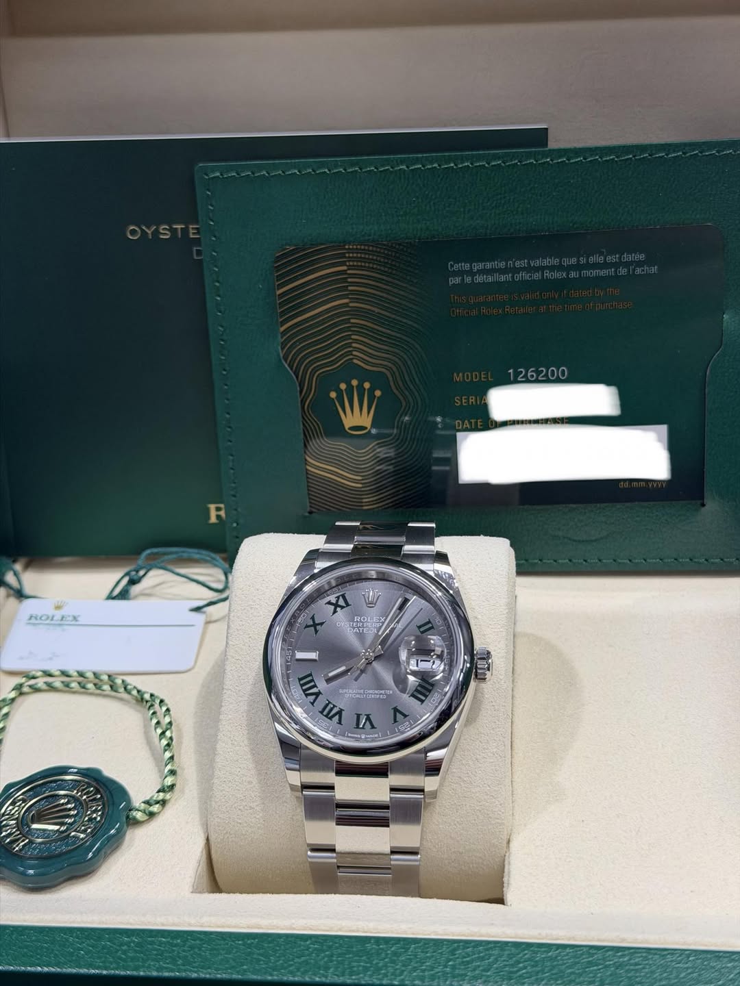 May be an image of wrist watch and text that says '126200 R ROLEX ROL 世 F ् VII ผ สวัด (De'