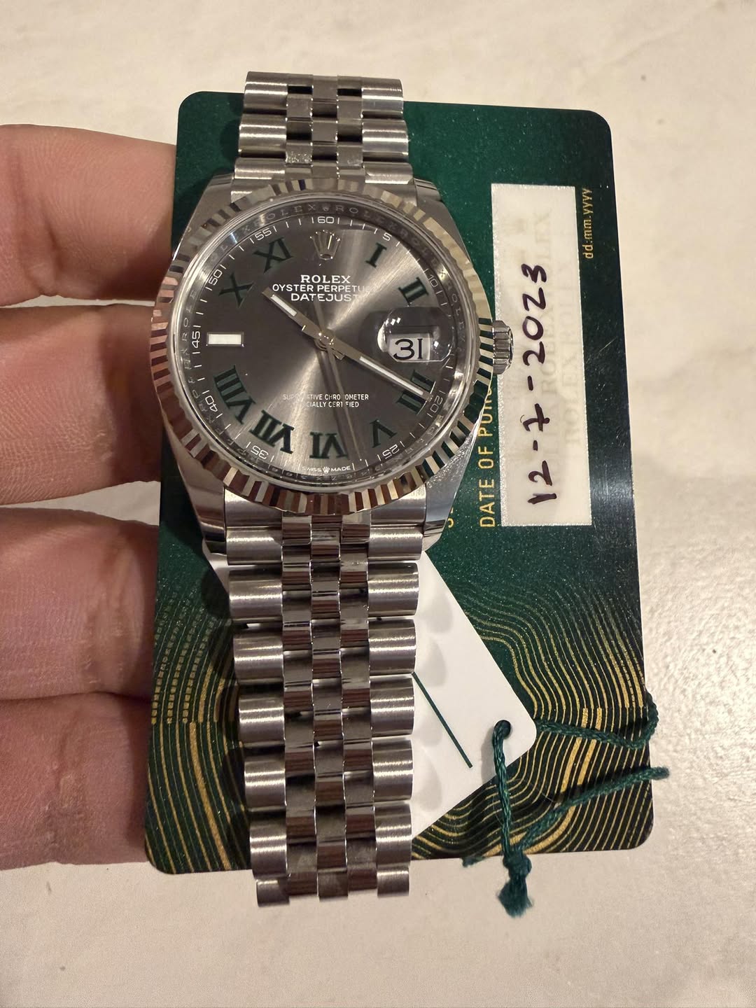 May be an image of wrist watch and text