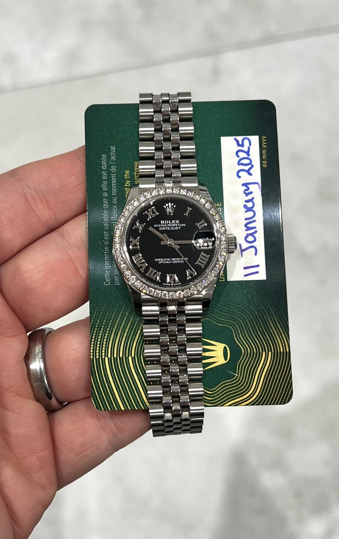 May be an image of wrist watch and text