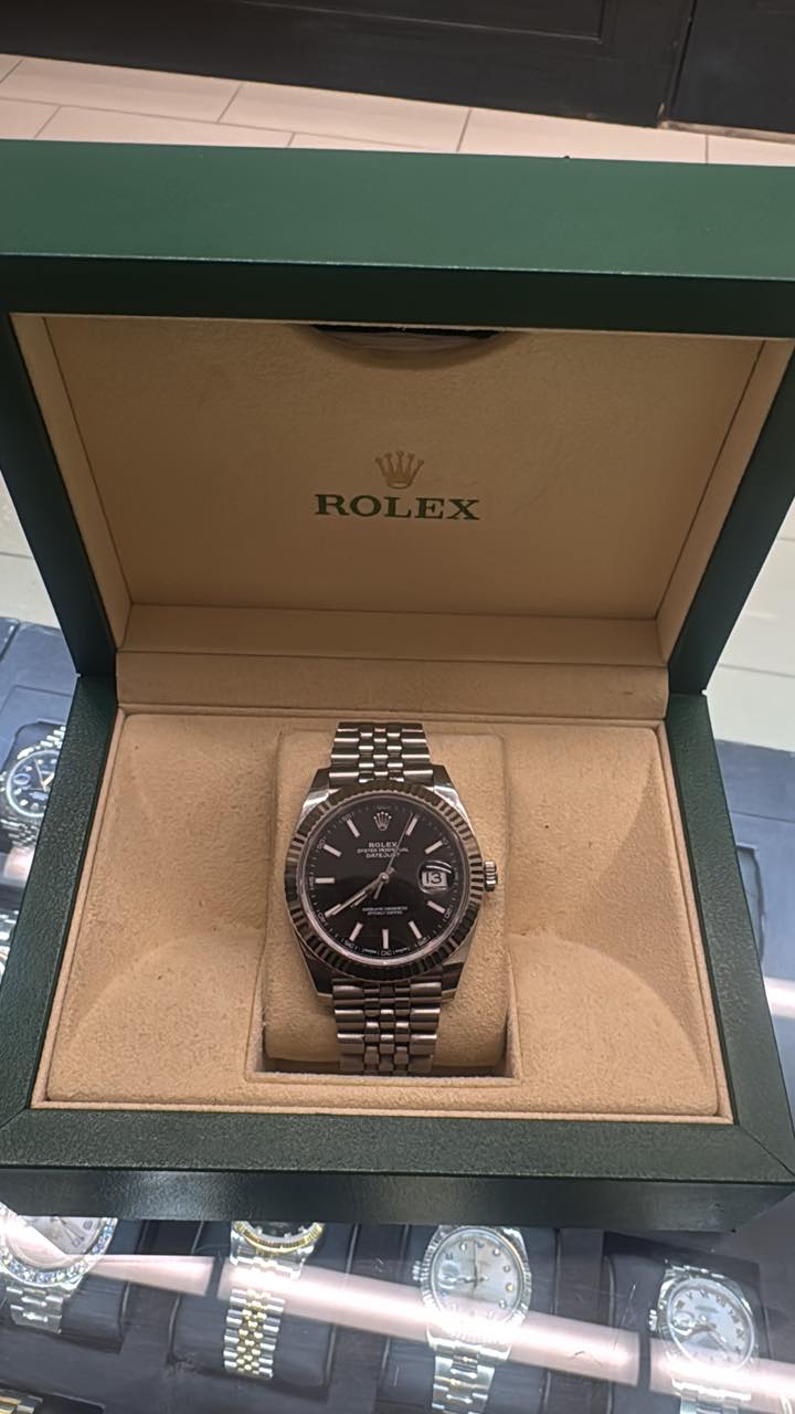 May be an image of wrist watch and text