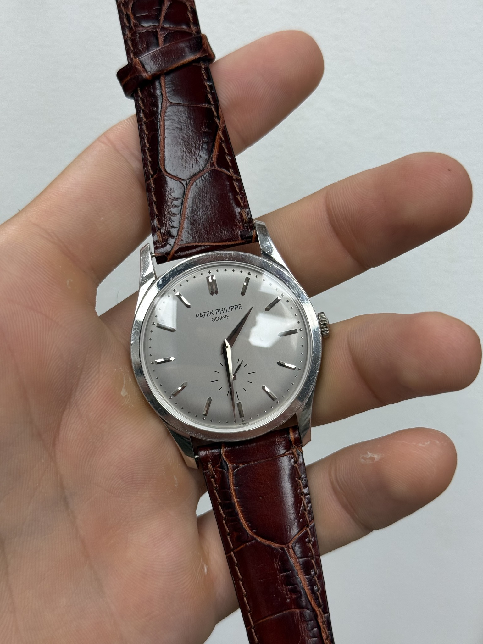 May be an image of wrist watch and text that says '• C 1 PATEK म PHILIPPE GENEVI'