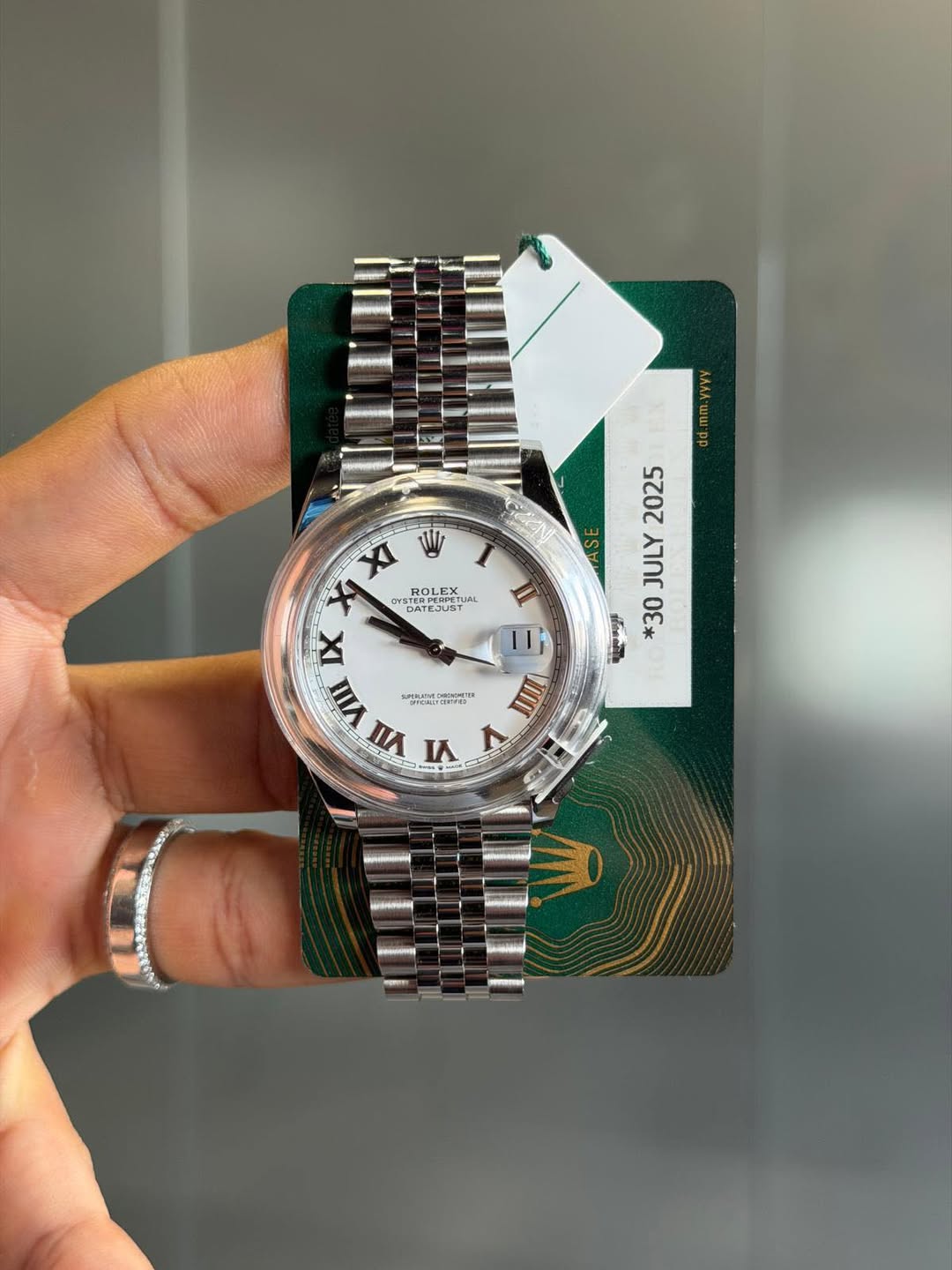 May be an image of wrist watch and text