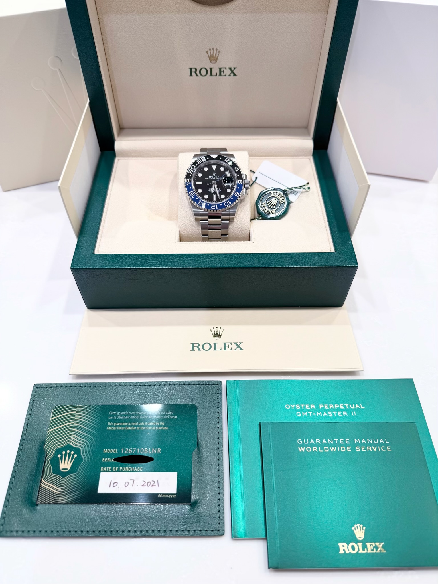 May be an image of wrist watch and text that says 'ROLEX 58 A 天 2 CO 20 .O O ROLEX woktora OYSTERPERPETUAL OYSTER PERPETUAL GMT-MASTERI MODEL 126710BLNR DATEOFPURCHASE OMTEO…