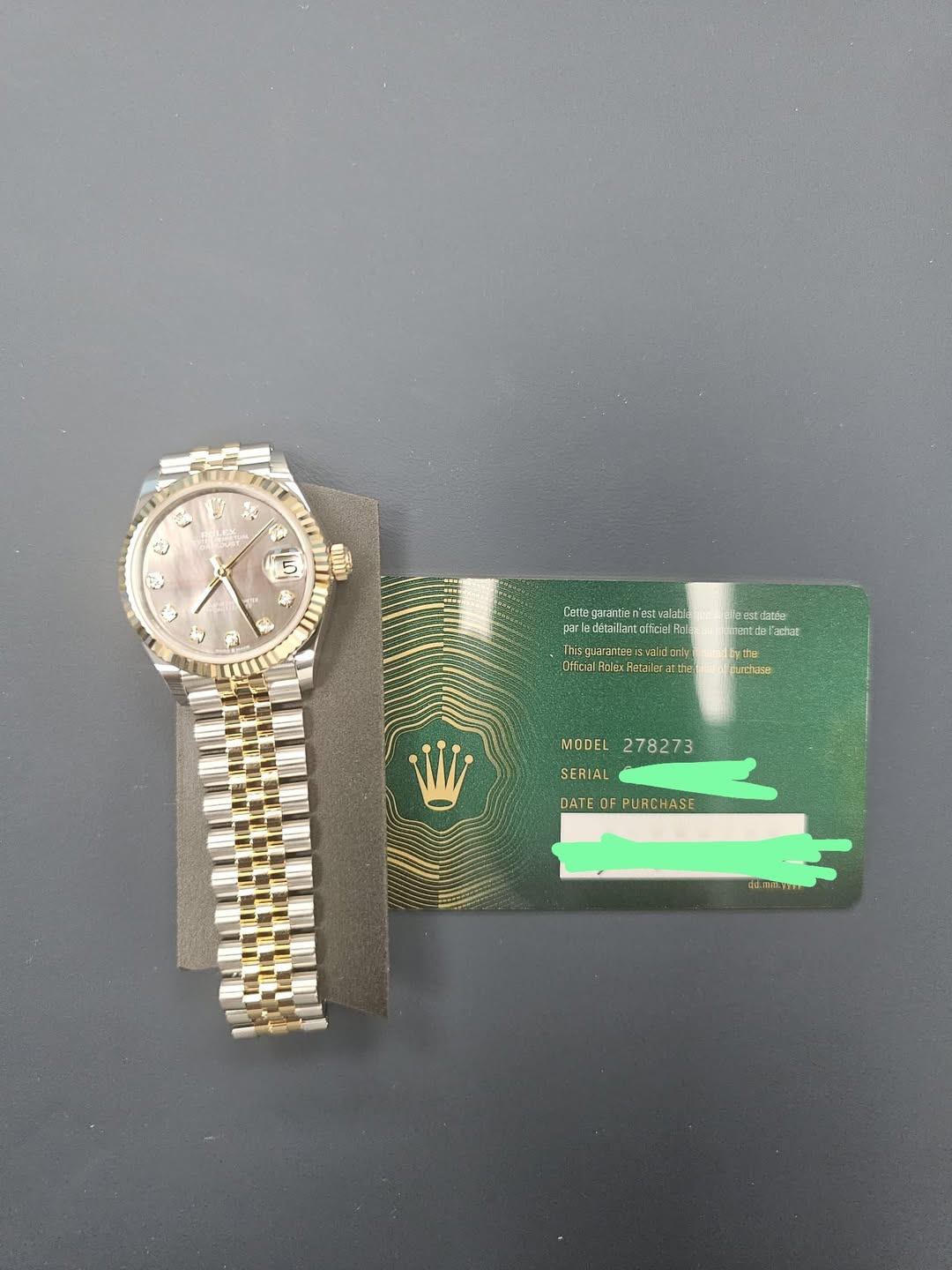 May be an image of money, wrist watch and text