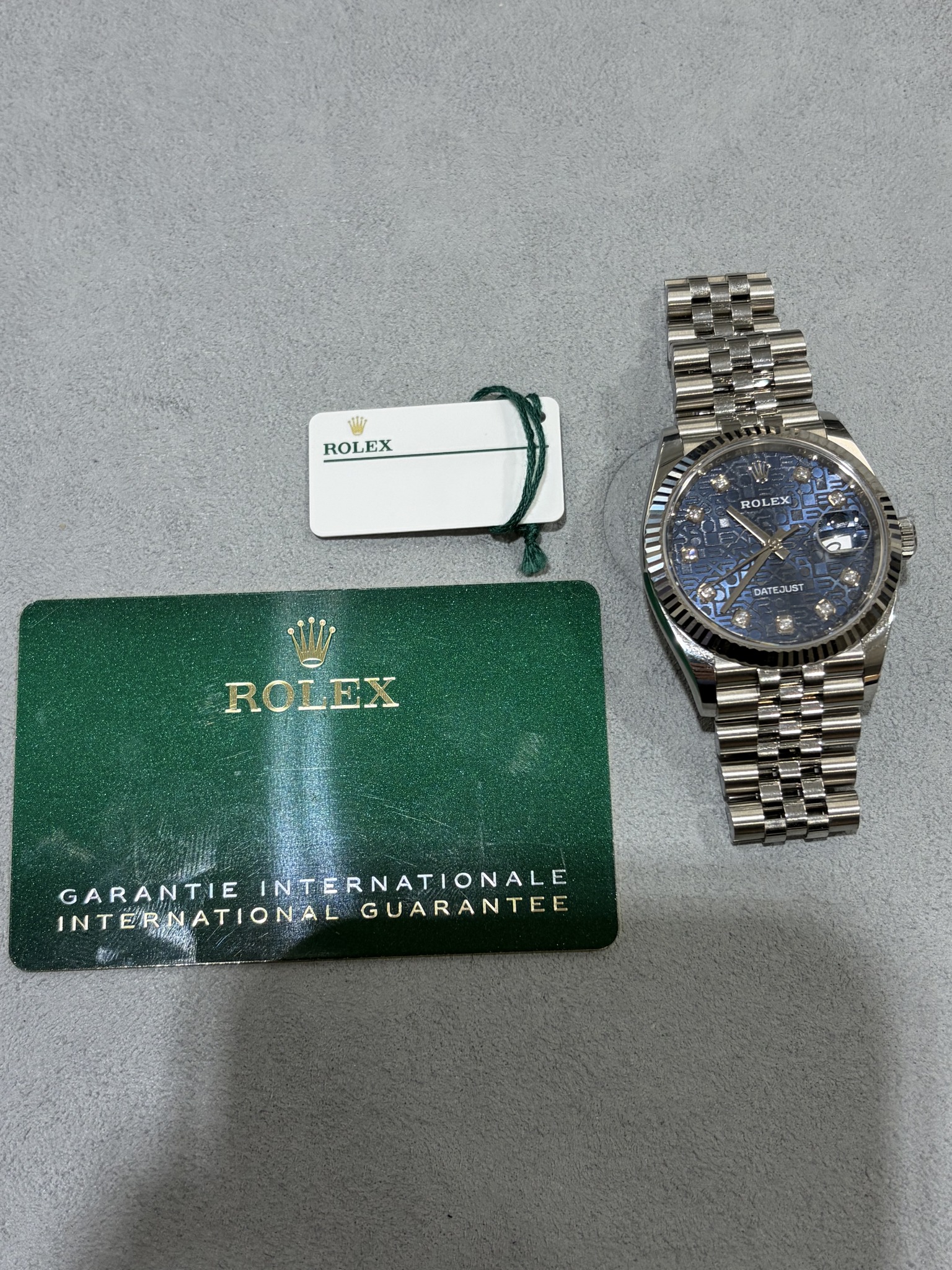 May be an image of wrist watch and text that says 'ROLEX יבל ROLEX EX DATEJUST ROLEX GARANTIE INTERNATIONALGUARANTEE GARANTIEINTERNATIONALE. INTERNATIONALE INTERNATIONAL INTERN…