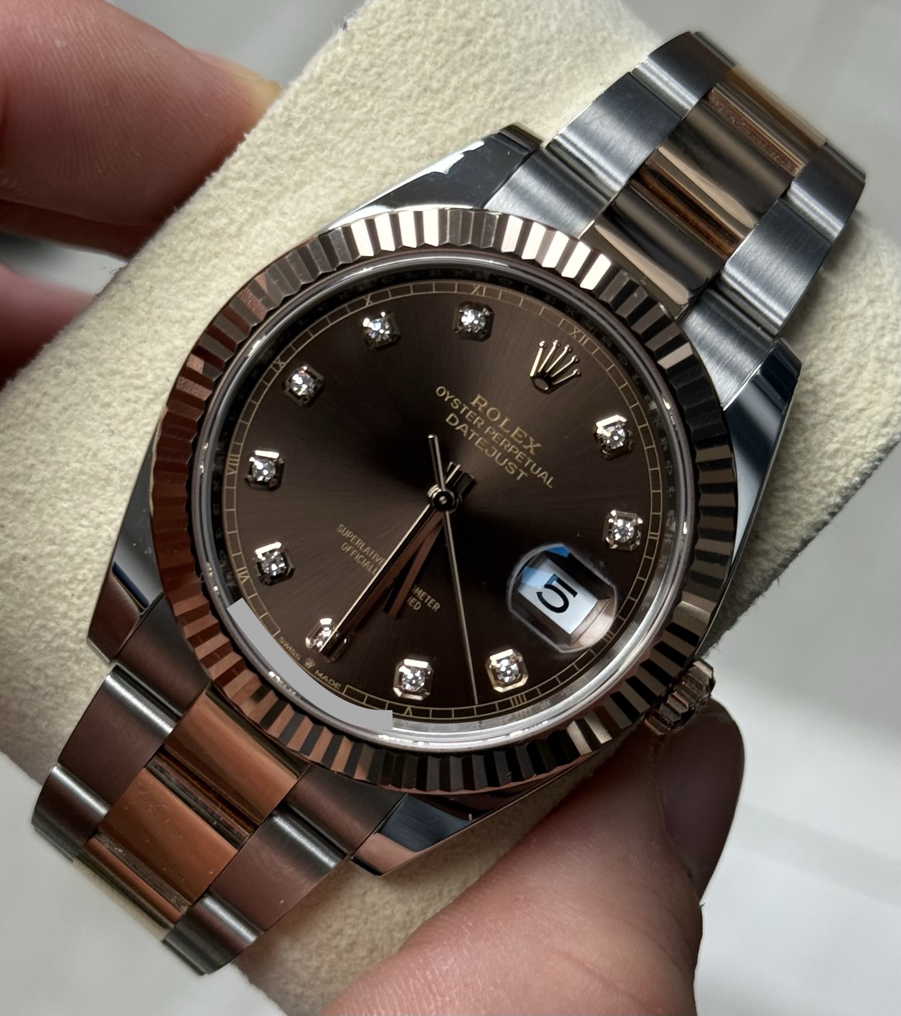 May be an image of wrist watch and text