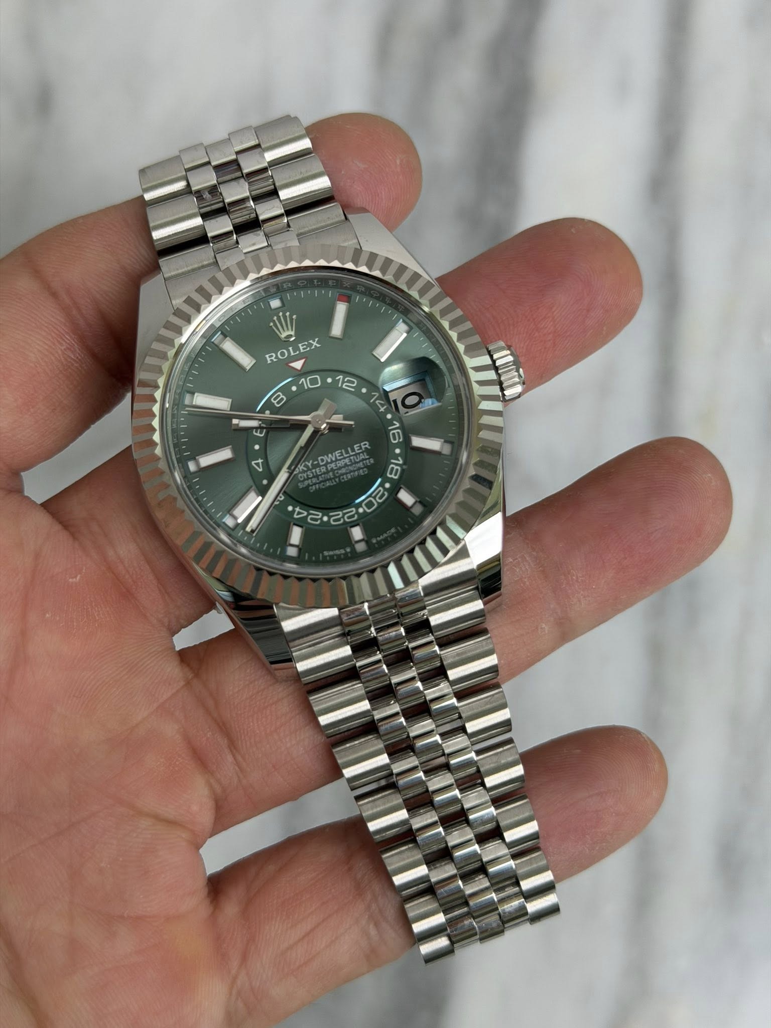 May be an image of wrist watch and text
