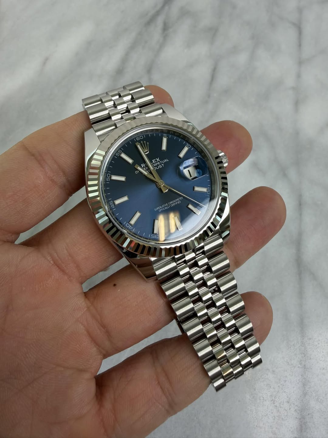 May be an image of wrist watch and text