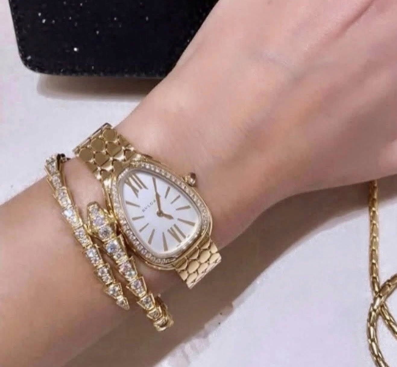May be an image of jewelry, wrist watch and text
